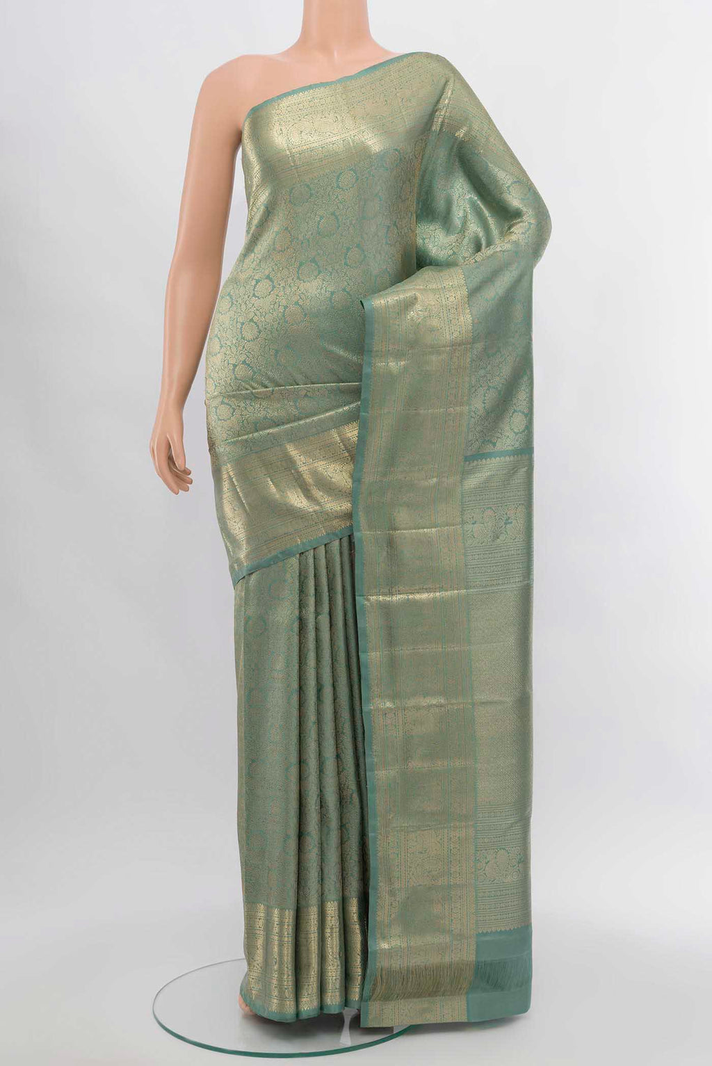 Mint Green Kanchipuram Silk Saree with Zari Butta on the body and Silk Border.  displayed on a mannequin