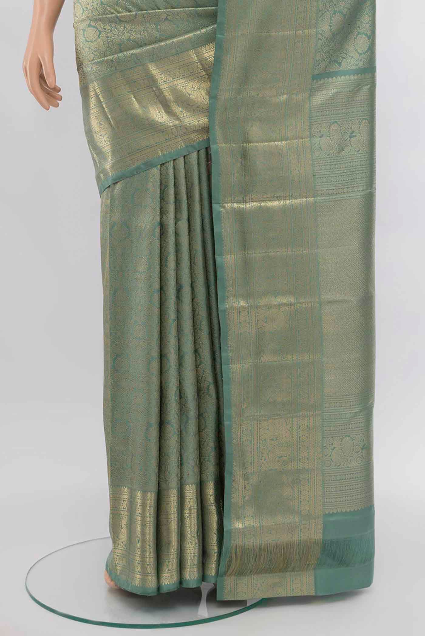 Pleats and pallu of Mint Green Kanchipuram Silk Saree with Zari Butta on the body and Silk Border. 