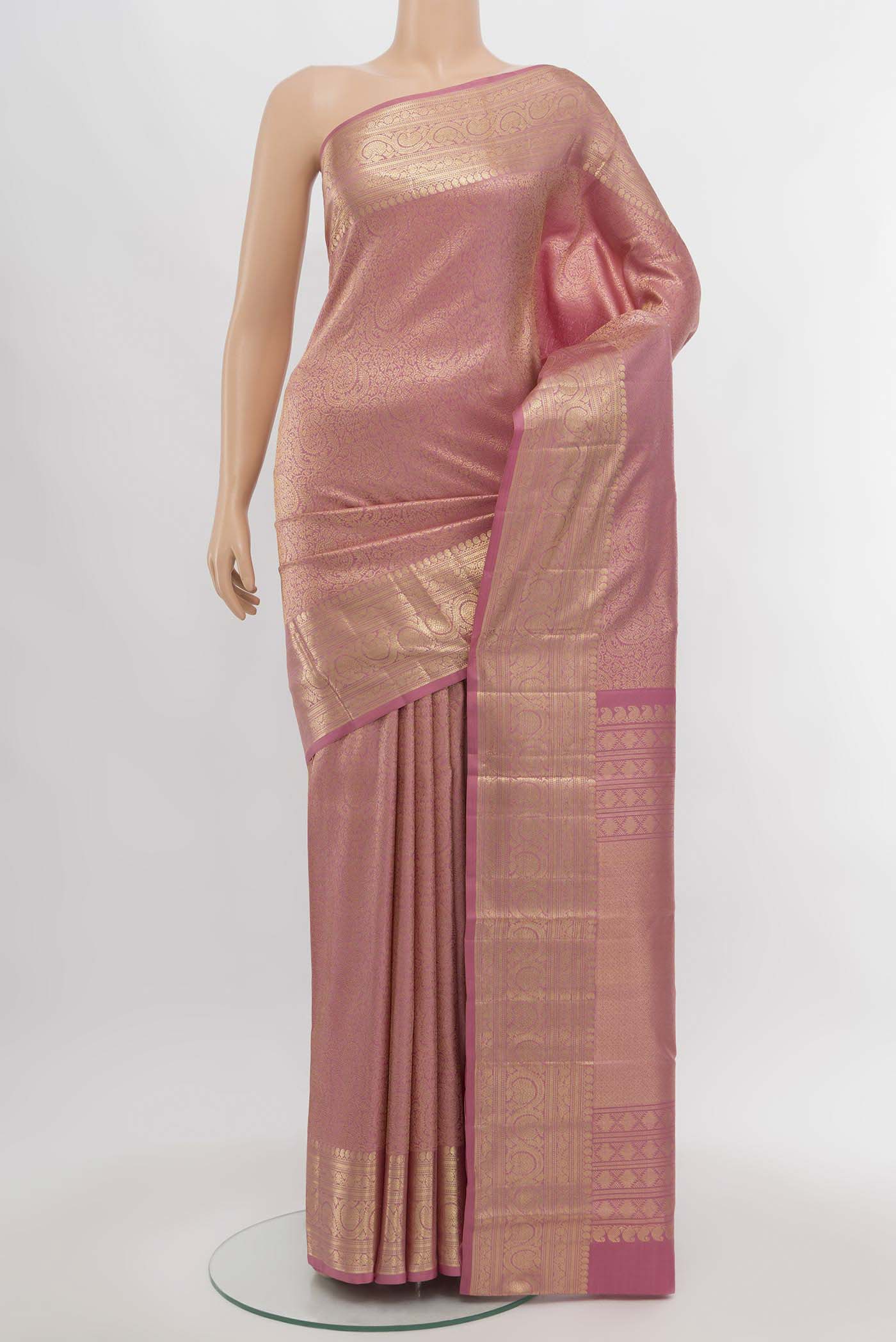 Golden Peach Kanchipuram Silk Saree with Zari Butta on the body and Silk Border.  displayed on a mannequin