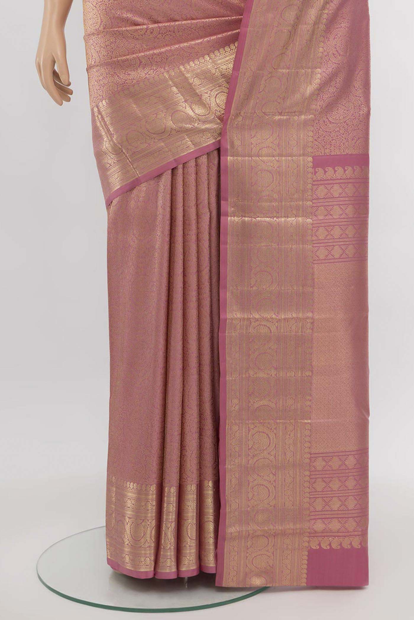 Pleats and pallu of Golden Peach Kanchipuram Silk Saree with Zari Butta on the body and Silk Border. 
