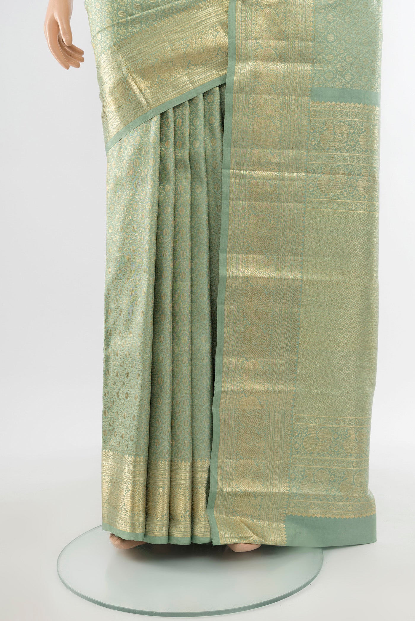 Pleats and pallu of Pure Silk Pure Zari Golden Kanchipuram Saree with Zari Butta on the body and Silk Border. 