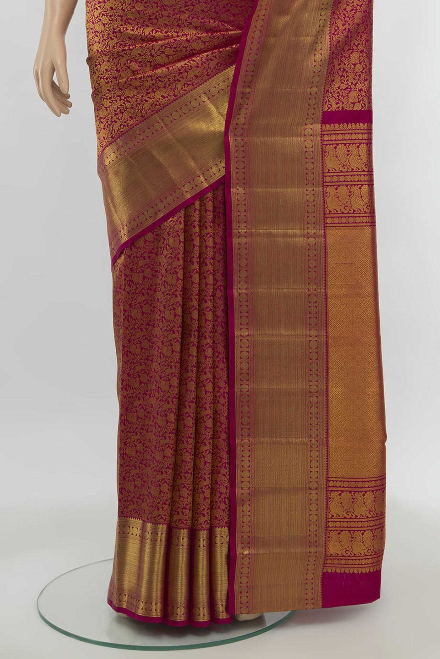 Pleats and pallu of Magenta Kanchipuram Silk Saree with Zari Butta on the body and Silk Border. 