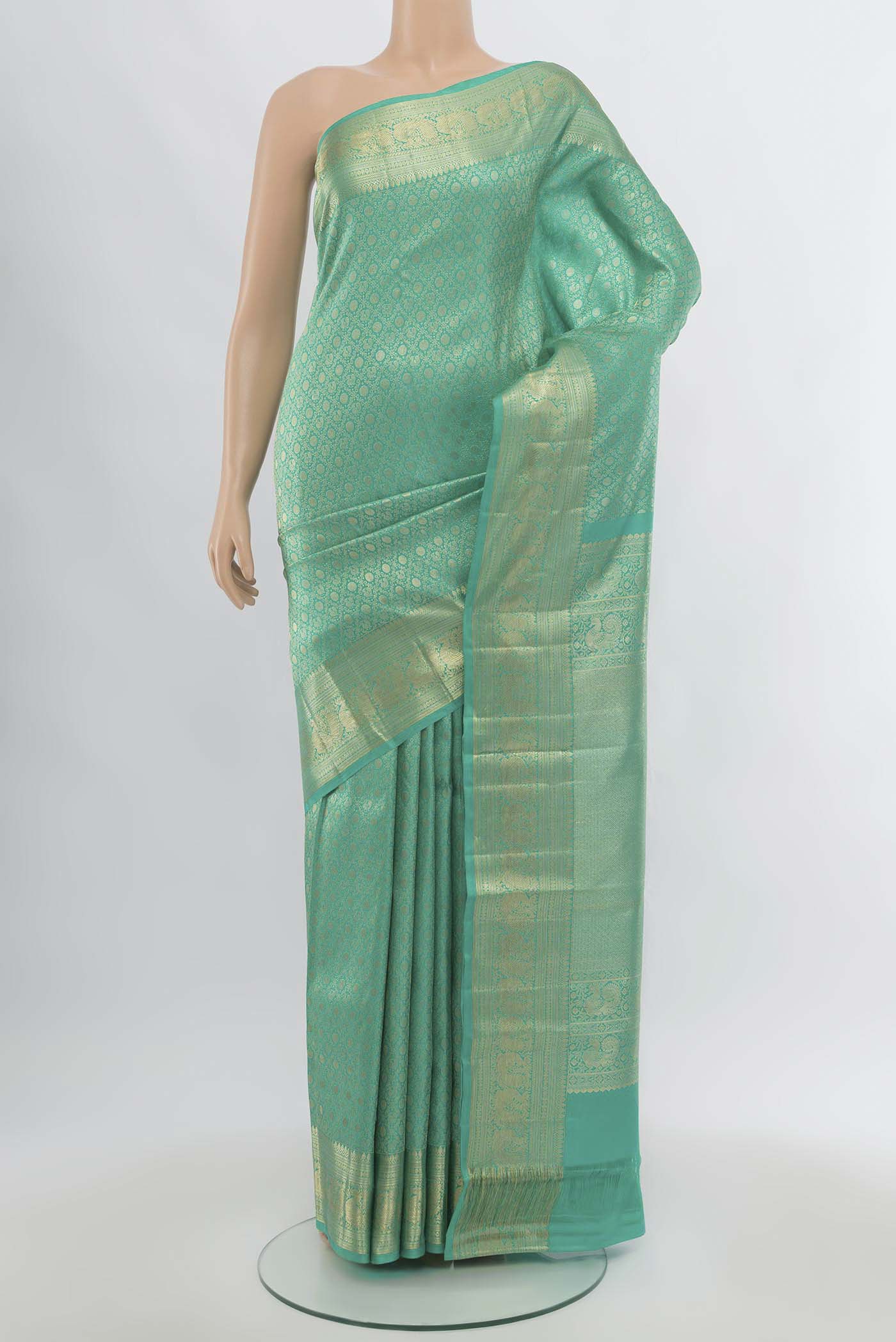 Sea Green Kanchipuram Silk Saree with Zari Butta on the body and Silk Border.  displayed on a mannequin
