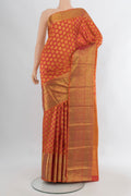 Brick Orange Kanchipuram Silk Saree with Zari Butta on the body and Zari Border.  displayed on a mannequin