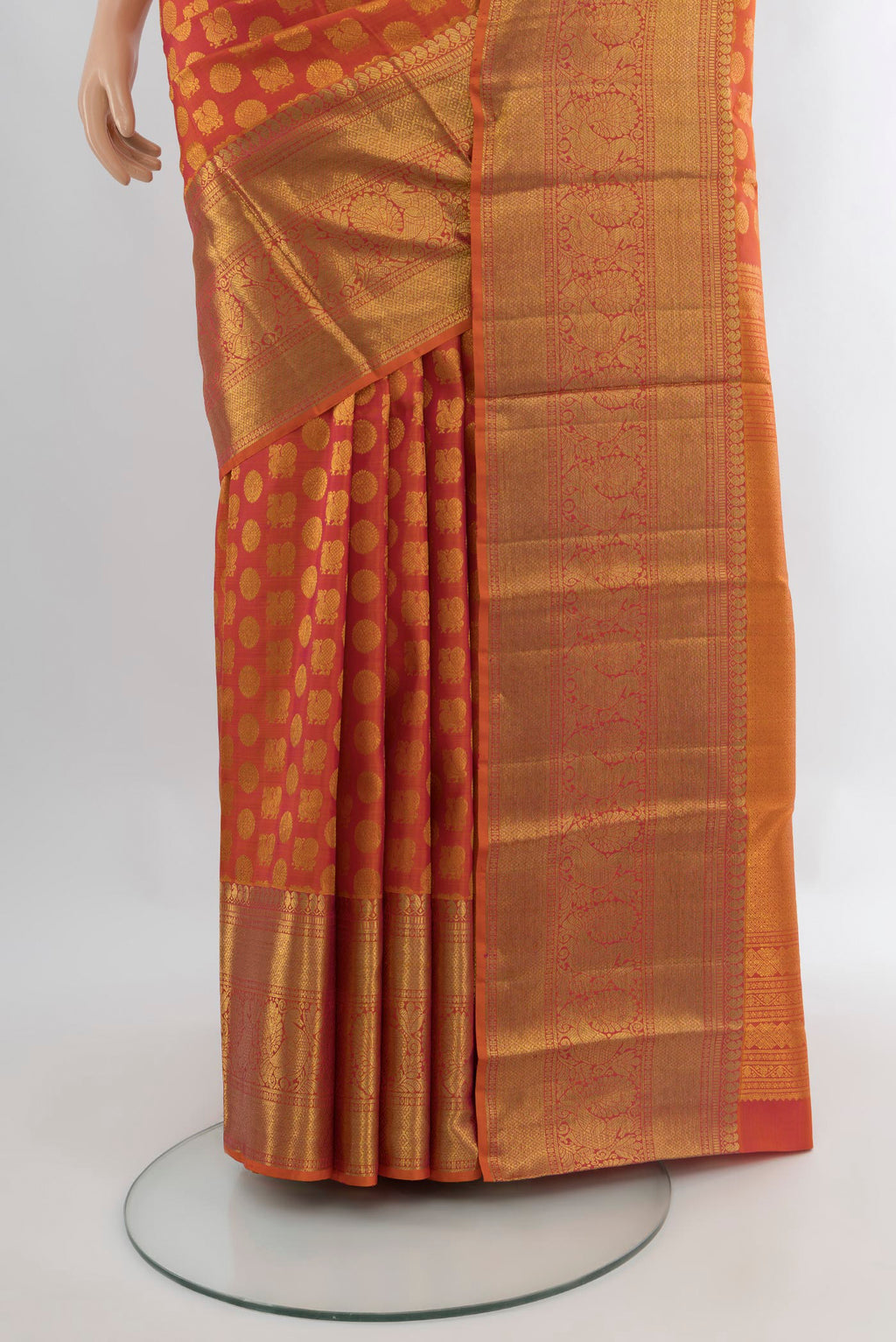 Pleats and pallu of Brick Orange Kanchipuram Silk Saree with Zari Butta on the body and Zari Border. 