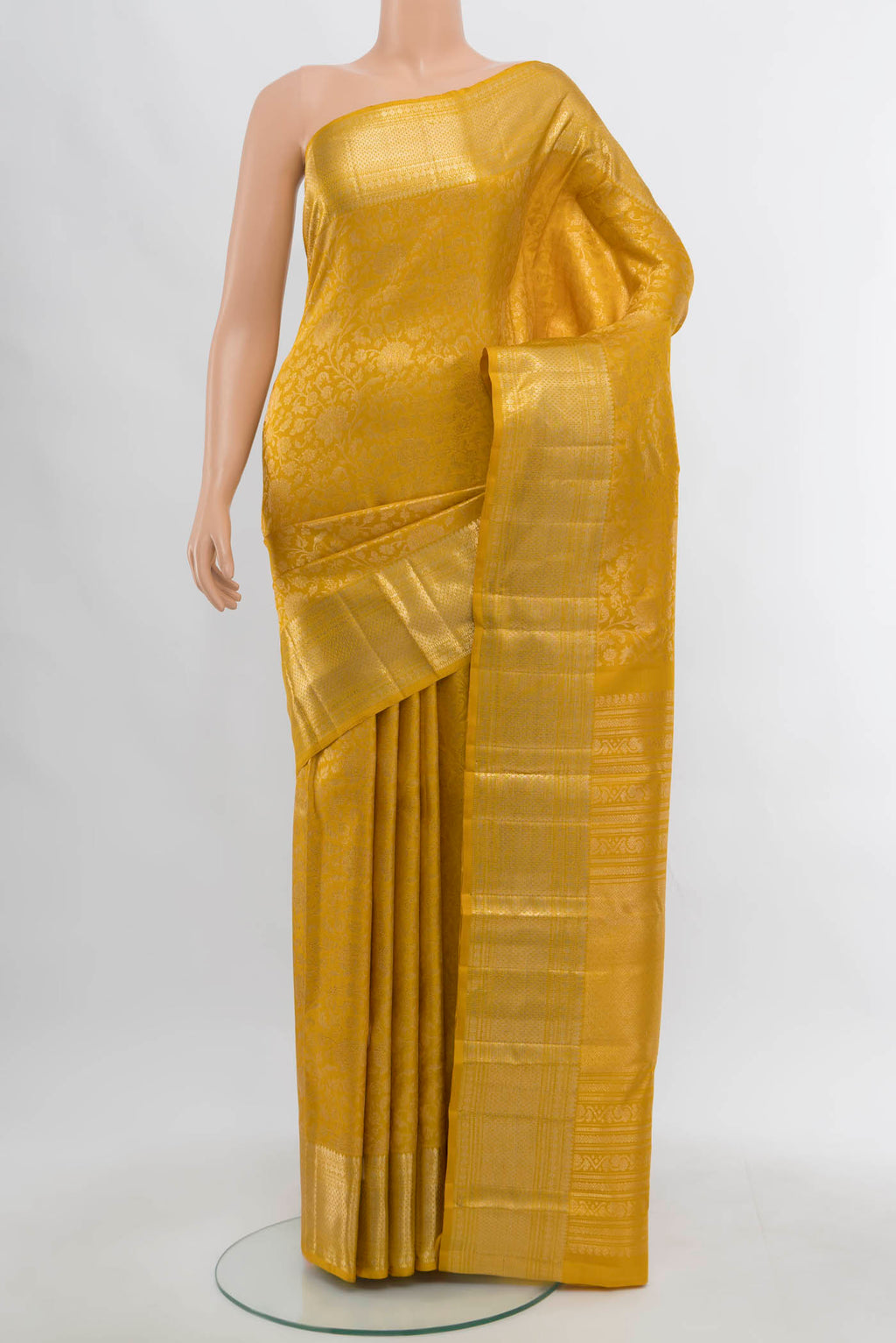 Yellow Kanchipuram Silk Saree with Zari Butta on the body and Silk Border.  displayed on a mannequin