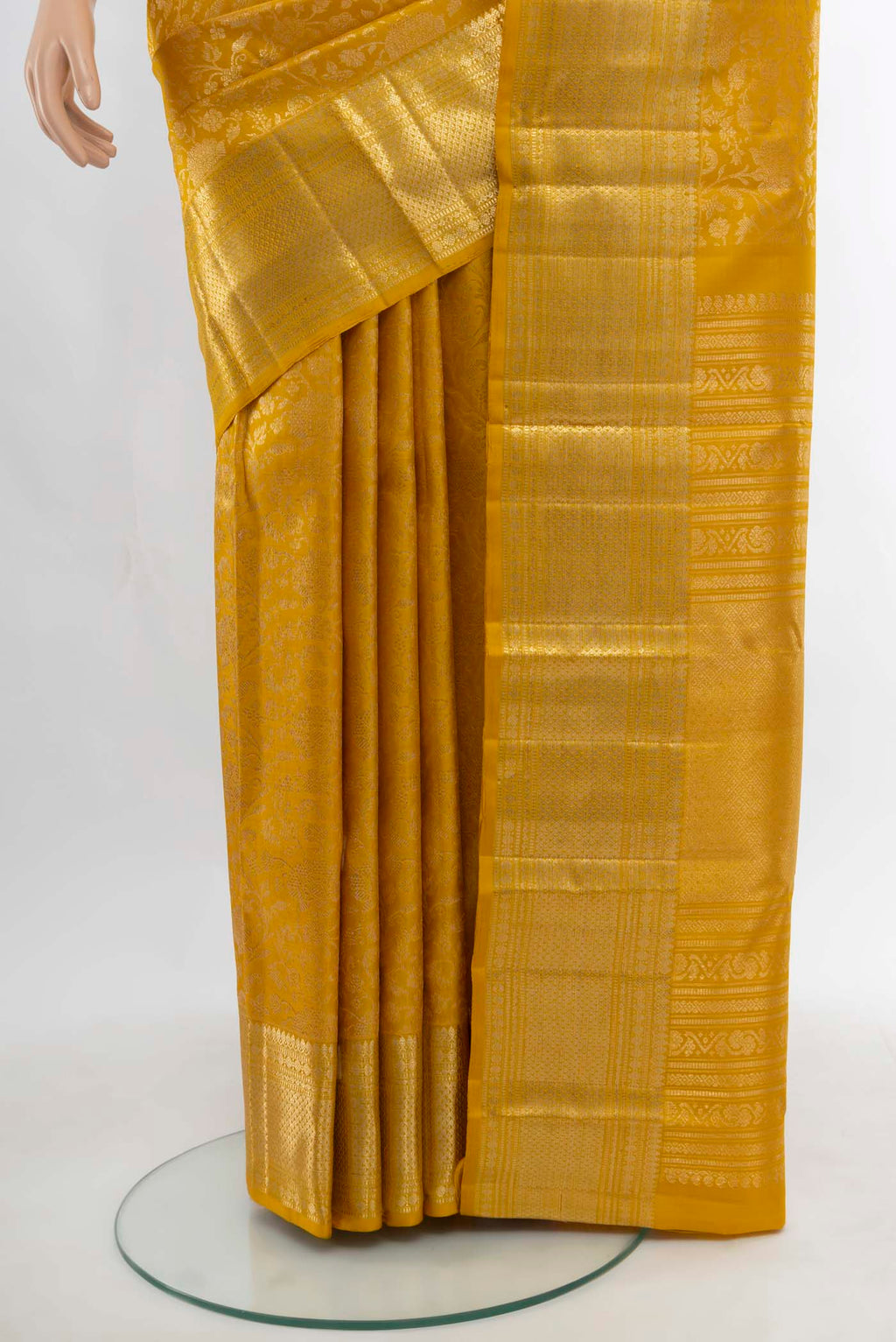 Pleats and pallu of Yellow Kanchipuram Silk Saree with Zari Butta on the body and Silk Border. 