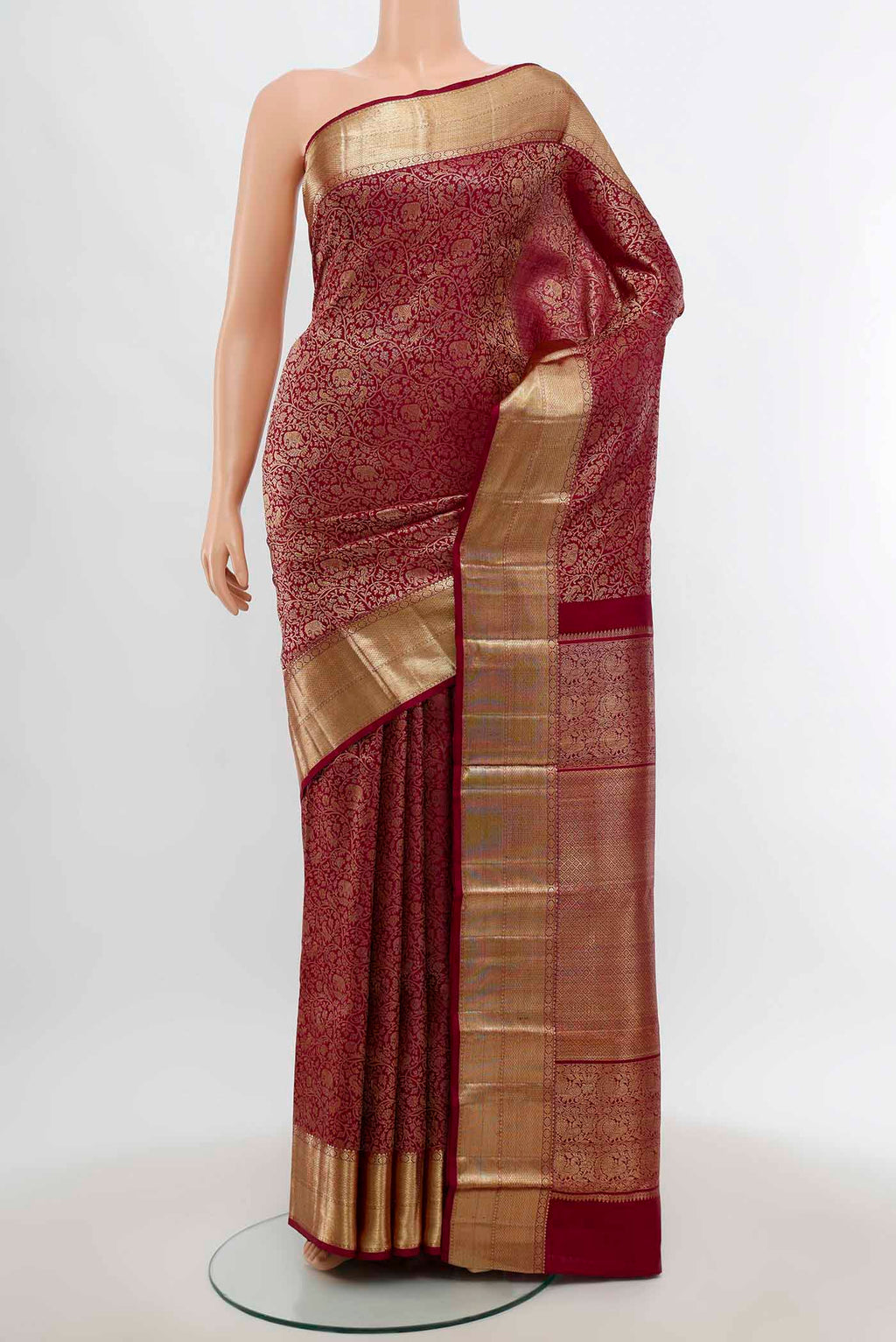 Maroon Kanchipuram Silk Saree with Zari Butta on the body and Silk Border.  displayed on a mannequin