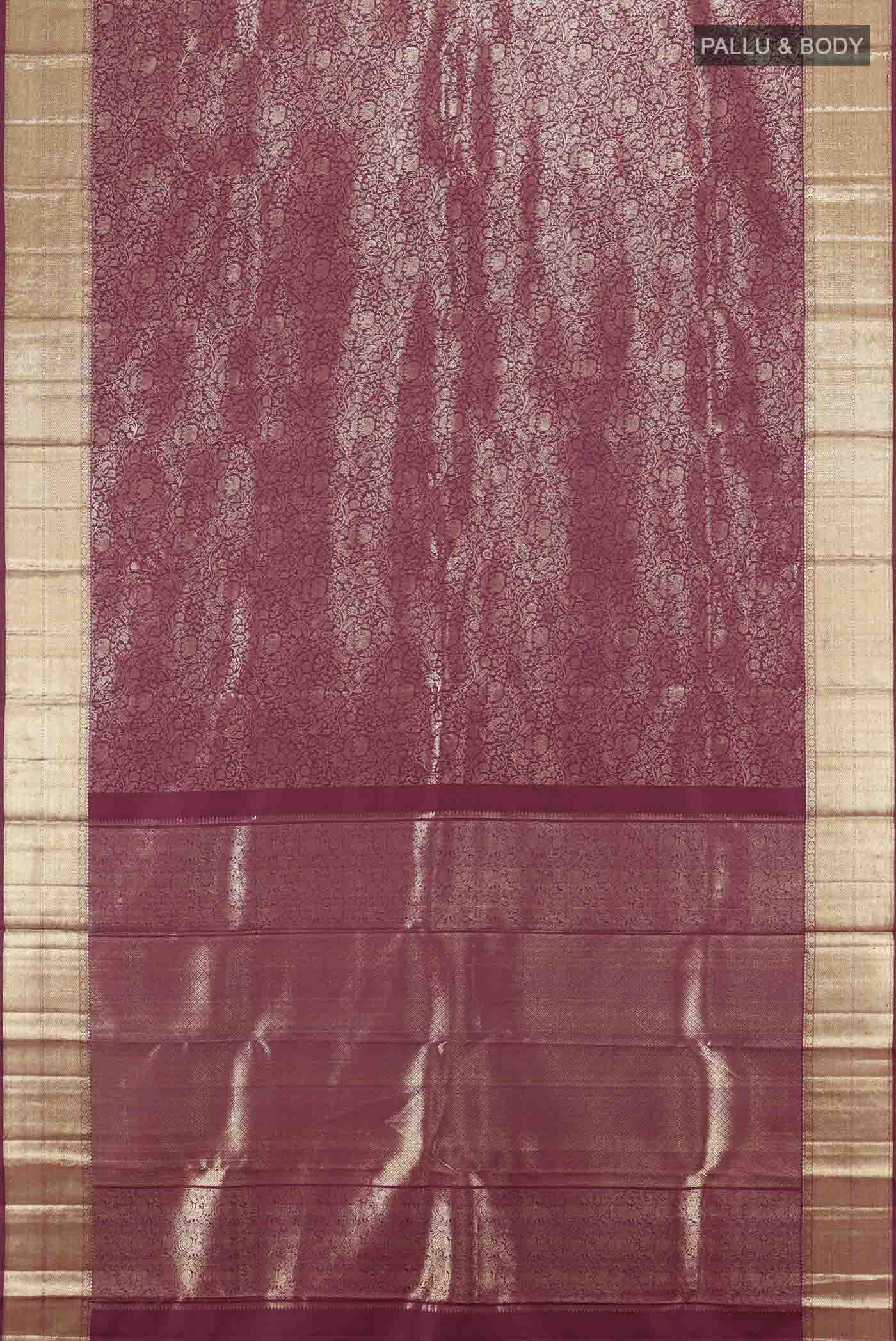 Flat view of Maroon Kanchipuram Silk Saree with Zari Butta on the body and Silk Border. 