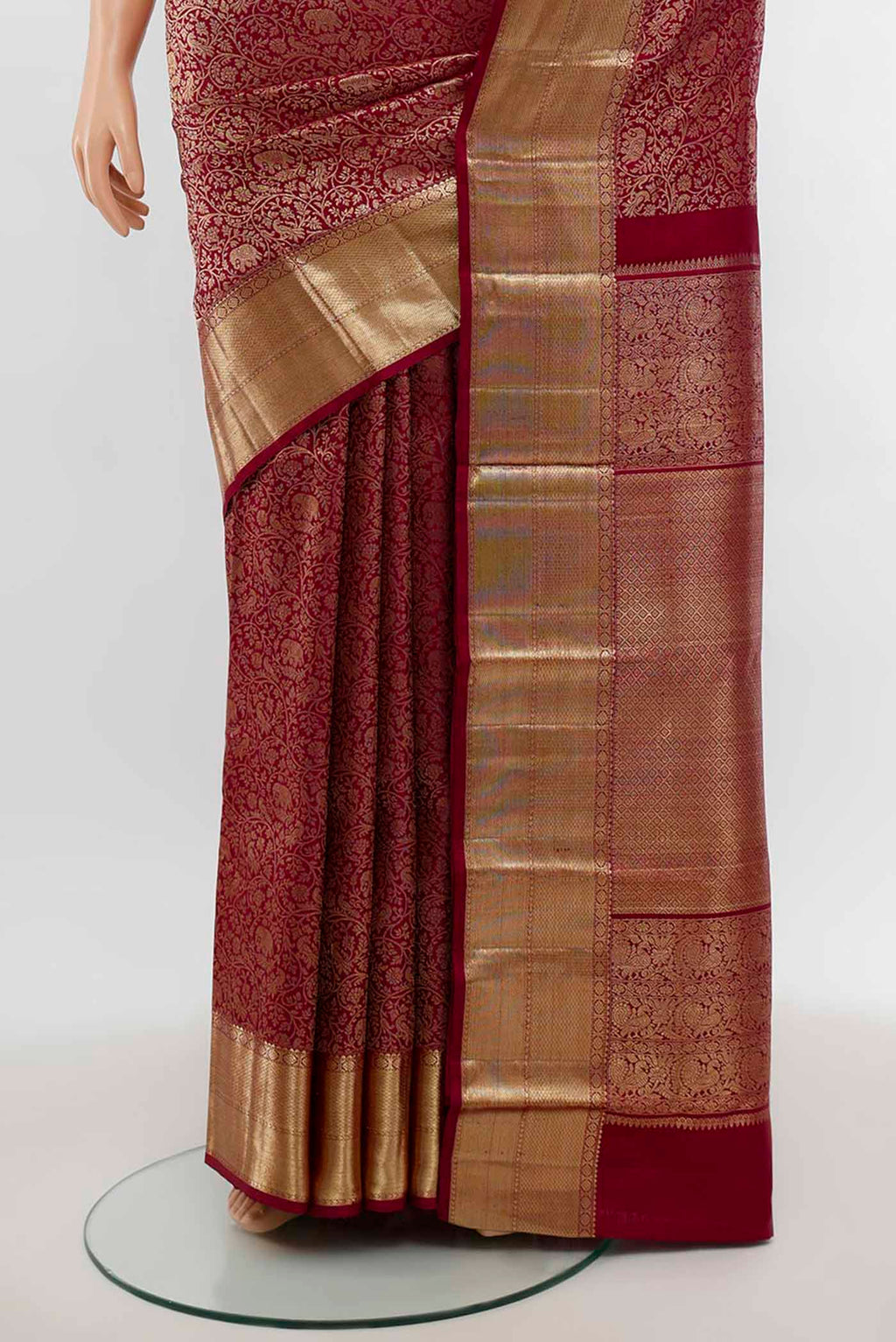 Pleats and pallu of Maroon Kanchipuram Silk Saree with Zari Butta on the body and Silk Border. 