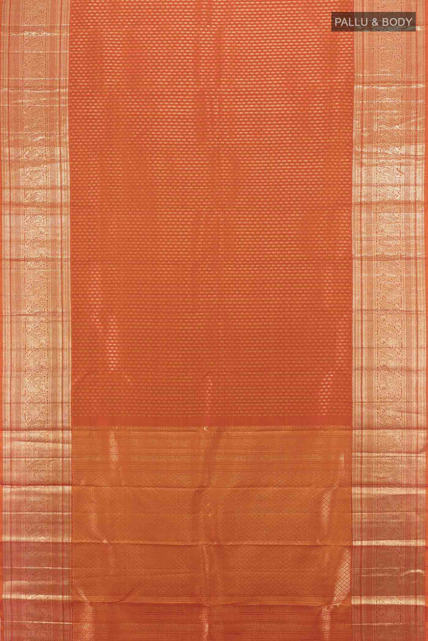 Flat view of Rust Kanchipuram Silk Saree with Zari Butta on the body and Silk Border. 
