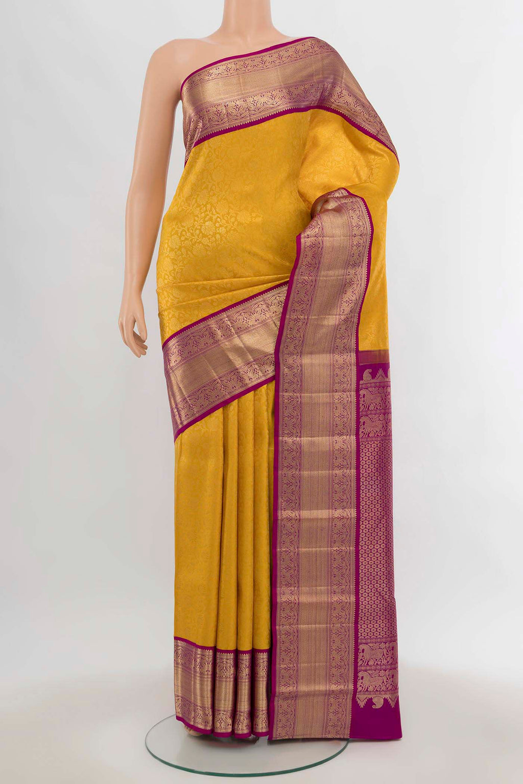 Yellow Kanchipuram Silk Saree with Zari Butta on the body and Silk Border.  displayed on a mannequin