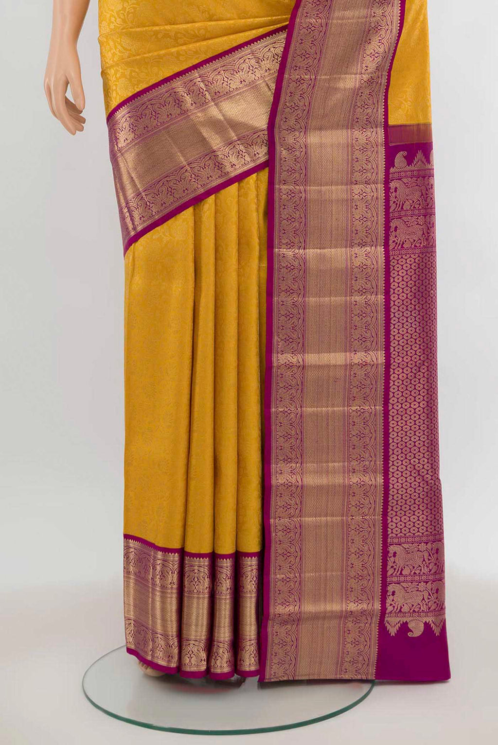 Pleats and pallu of Yellow Kanchipuram Silk Saree with Zari Butta on the body and Silk Border. 