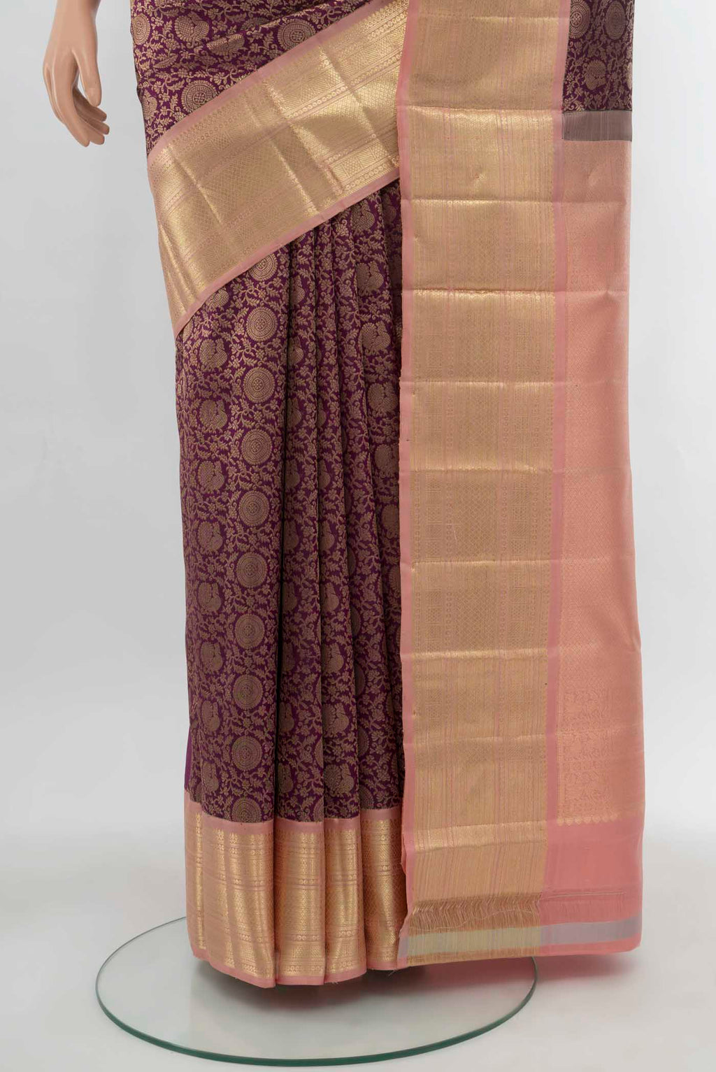 Pleats and pallu of Purple Kanchipuram Silk Saree with Zari Butta on the body and Silk Border. 