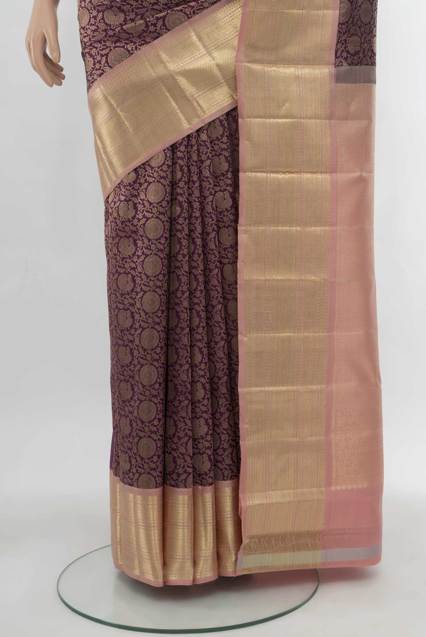Pleats and pallu of Purple Kanchipuram Silk Saree with Zari Butta on the body and Silk Border. 
