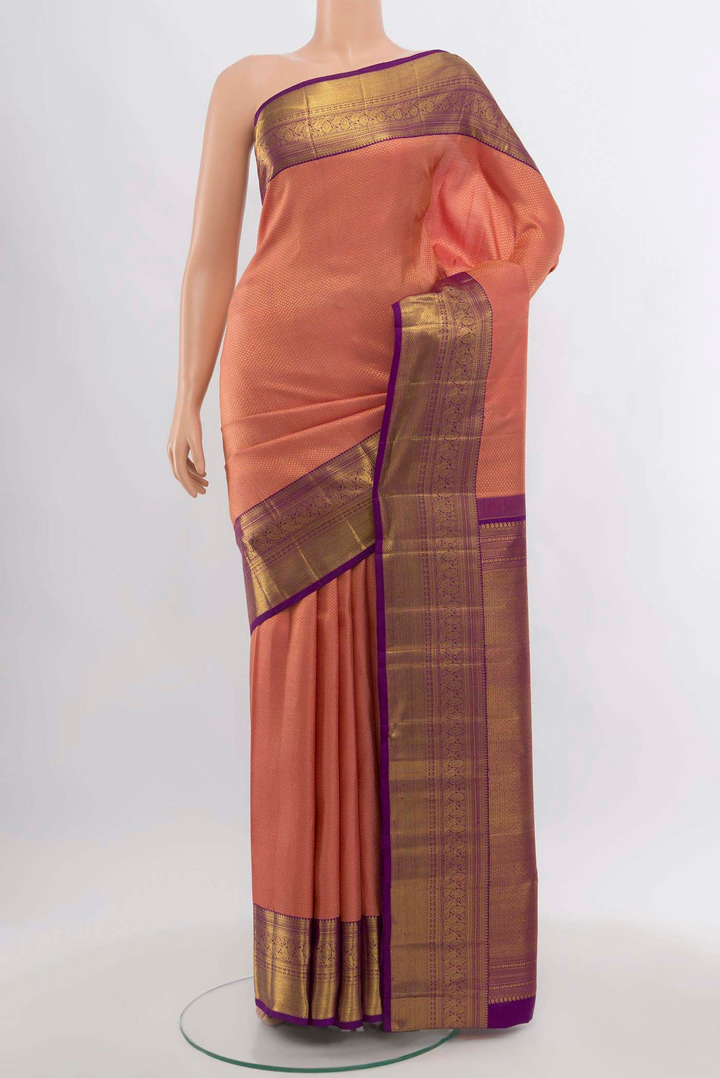 Peach Kanchipuram Silk Saree with Zari Butta on the body and Silk Border.  displayed on a mannequin