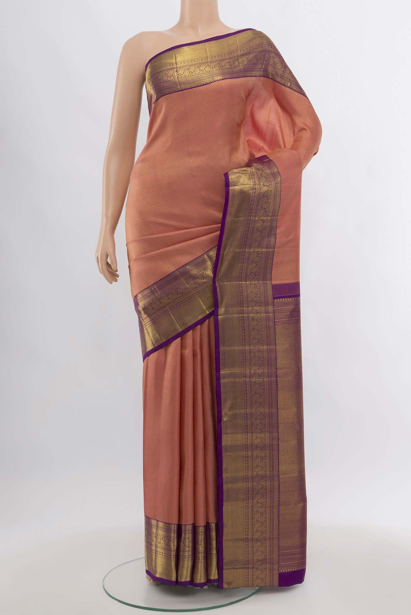 Peach Kanchipuram Silk Saree with Zari Butta on the body and Silk Border.  displayed on a mannequin