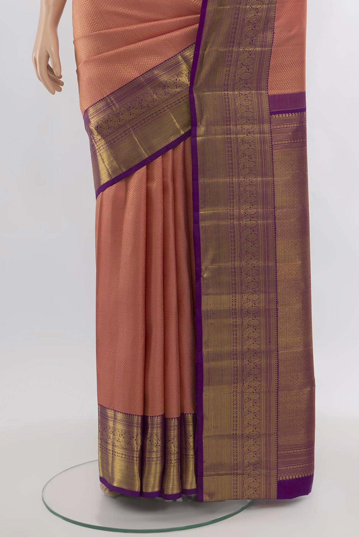 Pleats and pallu of Peach Kanchipuram Silk Saree with Zari Butta on the body and Silk Border. 