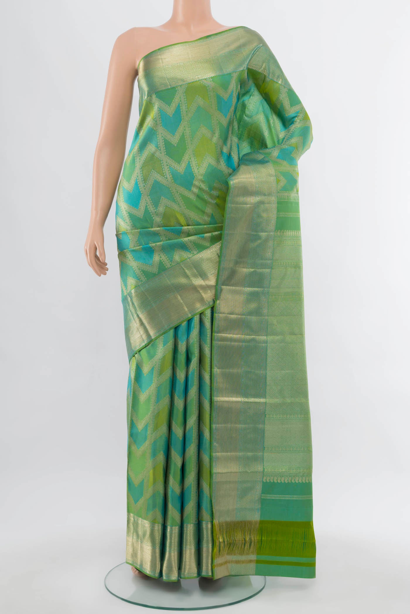 Light Green Kanjivaram Silk Saree with Zari Butta on the body and Silk Border.  displayed on a mannequin