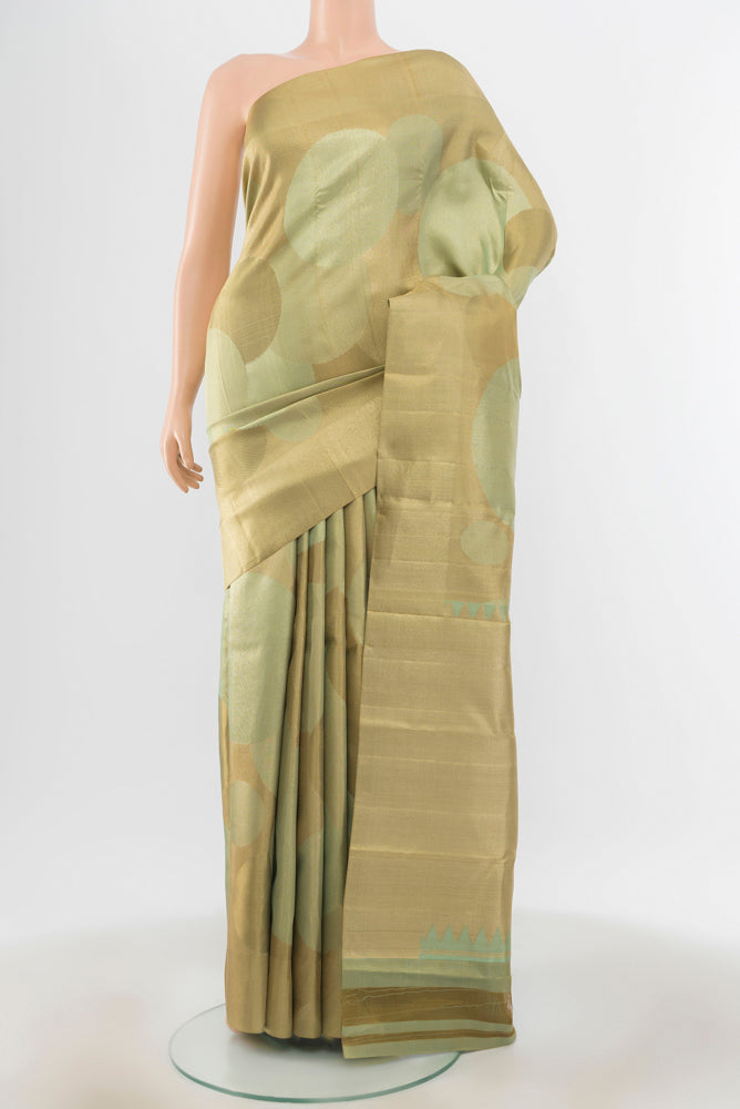 Golden Kanjivaram Silk Saree with Zari Brocade on the body and Silk Border.  displayed on a mannequin