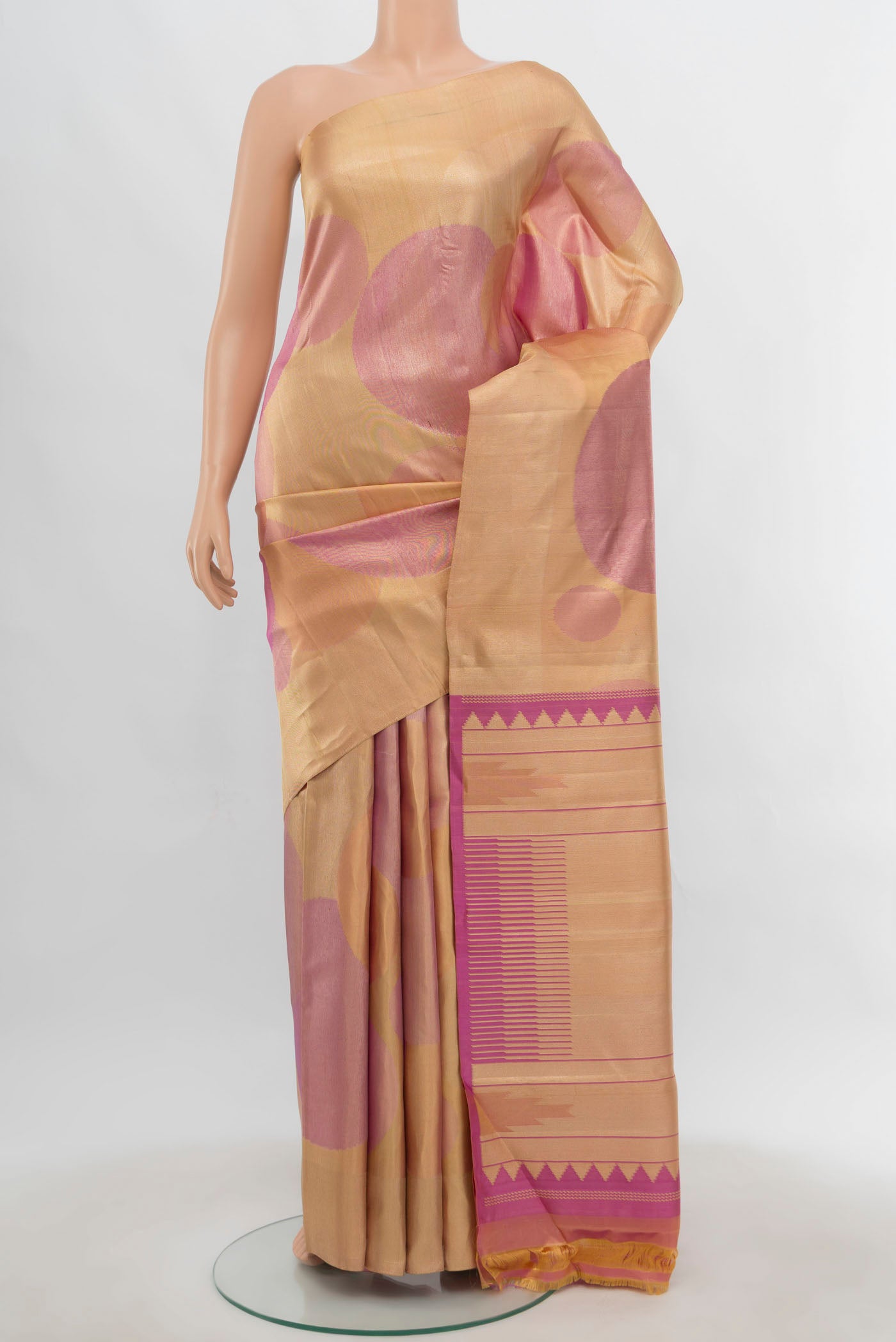 Rose Gold Kanjivaram Silk Saree with Zari Butta on the body and Silk Border.  displayed on a mannequin
