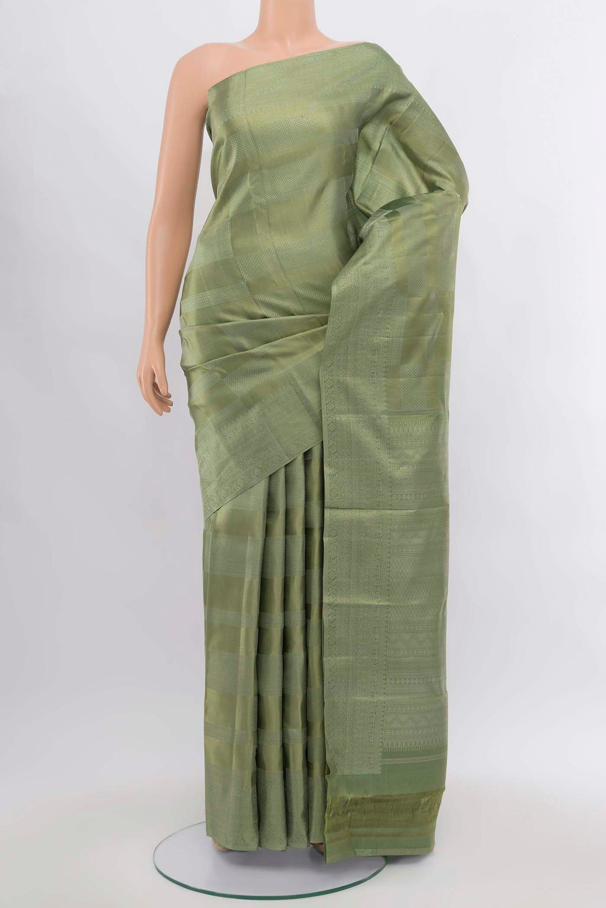 Pista Green Kanjivaram Silk Saree with Zari Butta on the body and Silk Border.  displayed on a mannequin