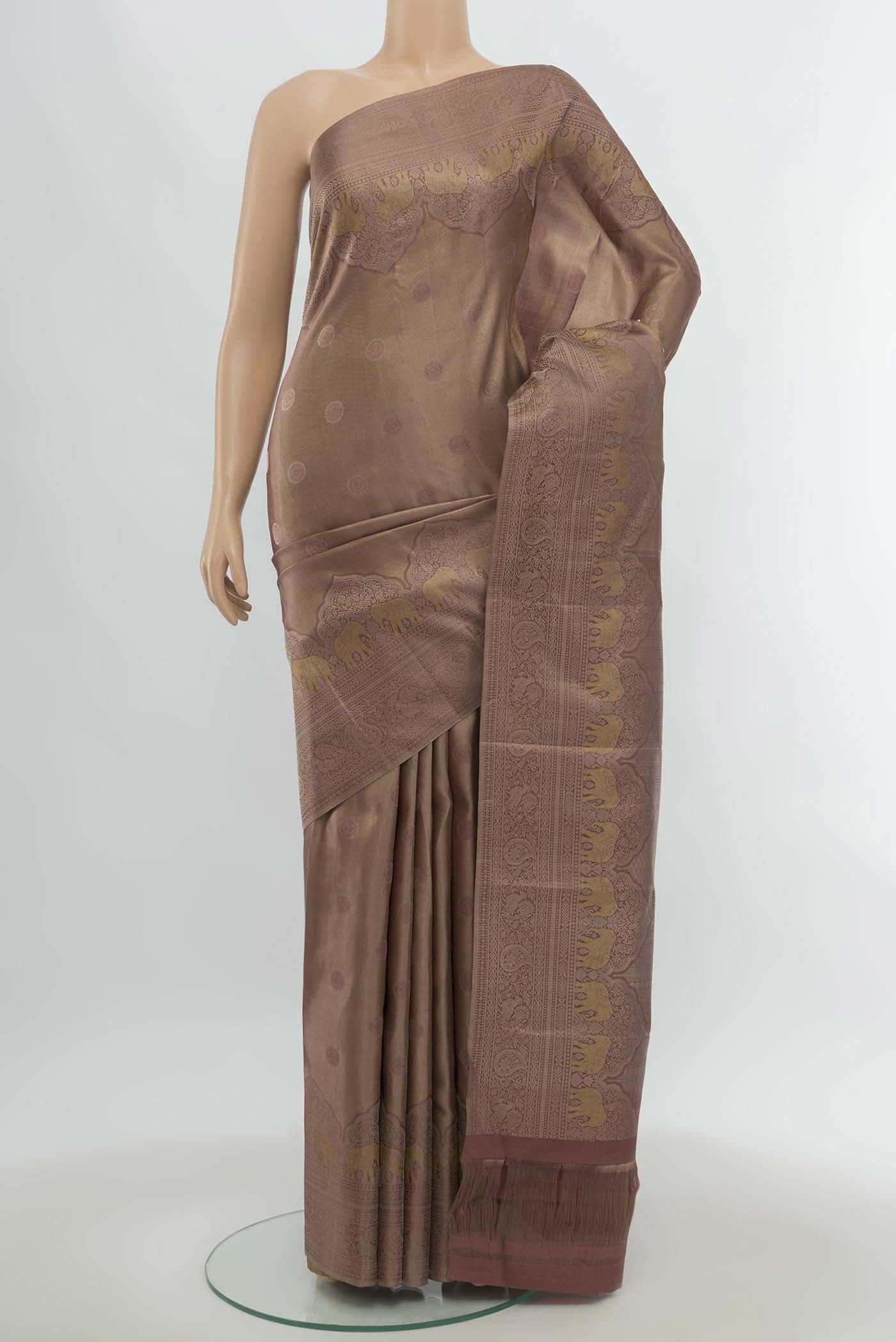 Dark Beige Kanjivaram Silk Saree with Zari Butta on the body and Silk Border.  displayed on a mannequin