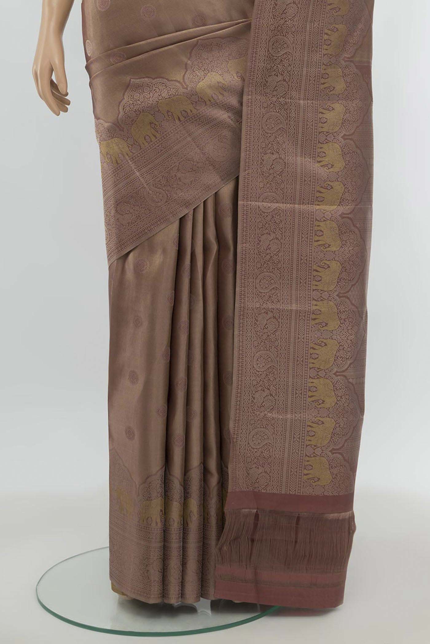 Pleats and pallu of Dark Beige Kanjivaram Silk Saree with Zari Butta on the body and Silk Border. 