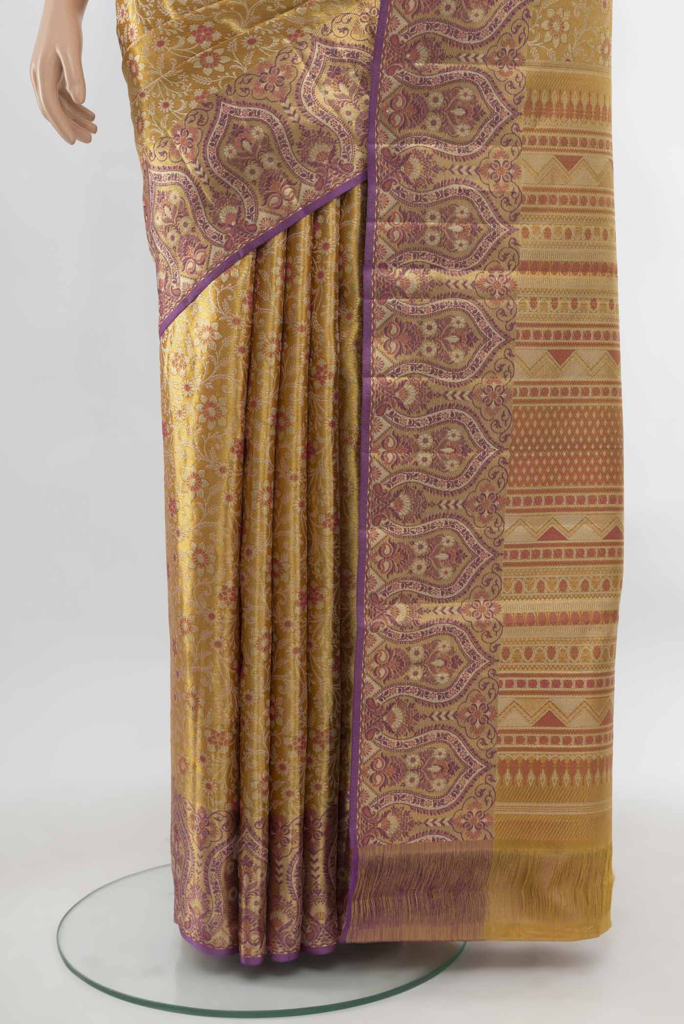 Pleats and pallu of Pure Silk Pure Zari Golden Kanchipuram Saree with Zari Butta on the body and Silk Border. 