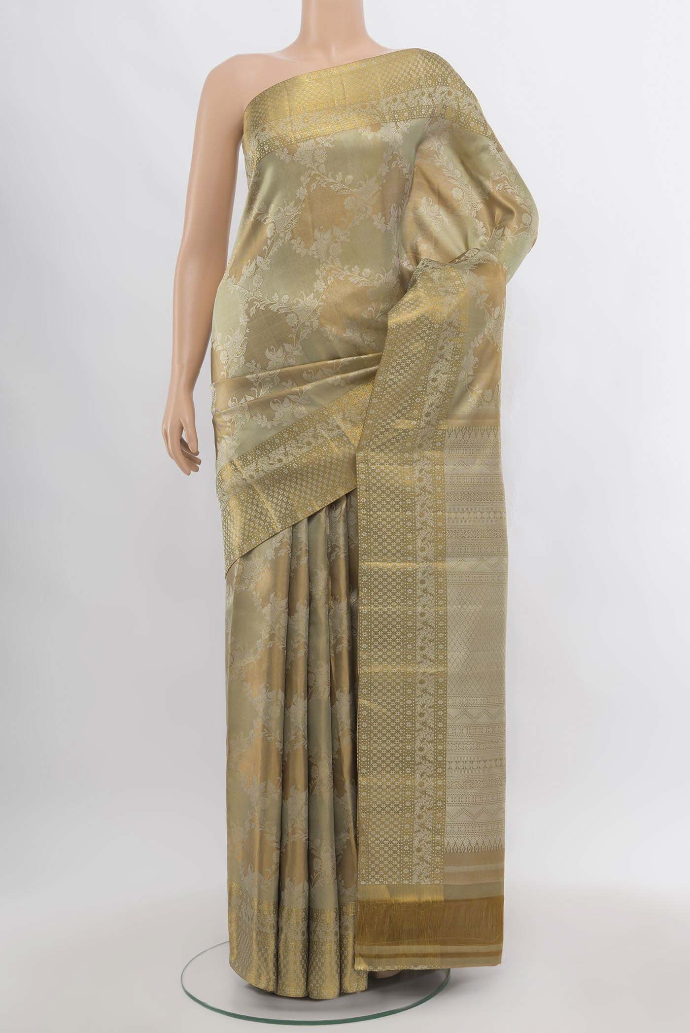 Golden Kanjivaram Silk Saree with Zari Butta on the body and Silk Border.  displayed on a mannequin