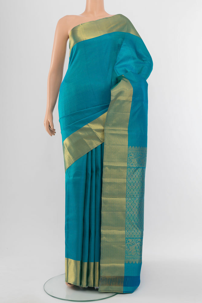 Light Blue Kanjivaram Silk Saree with Zari Butta on the body and Silk Border.  displayed on a mannequin