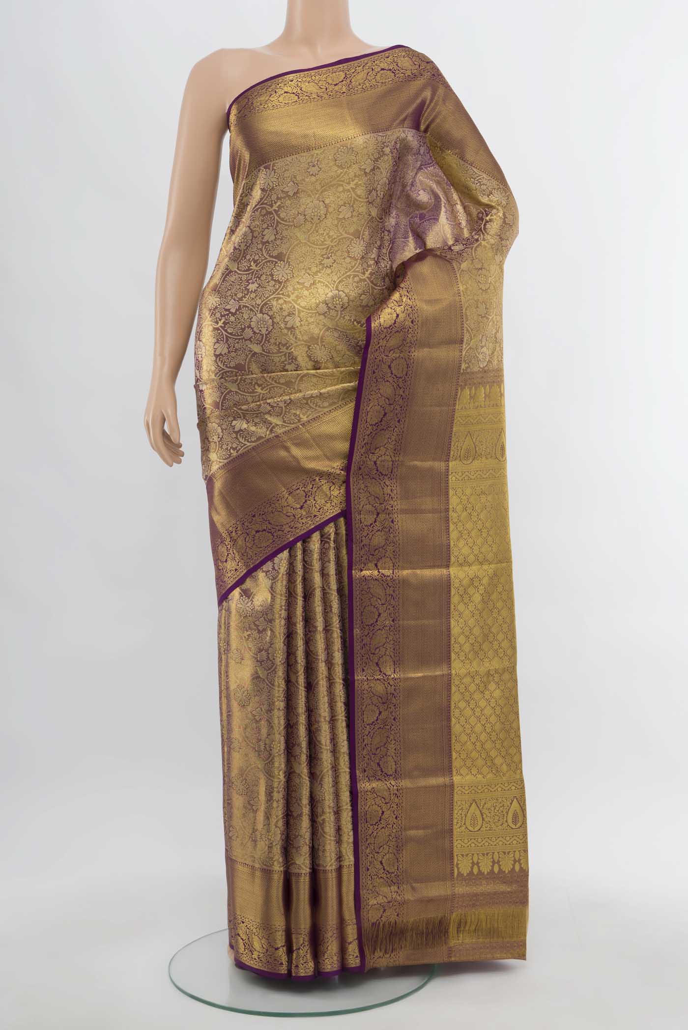 Golden Kanchipuram Silk Saree with Zari Butta on the body and Silk Border.  displayed on a mannequin