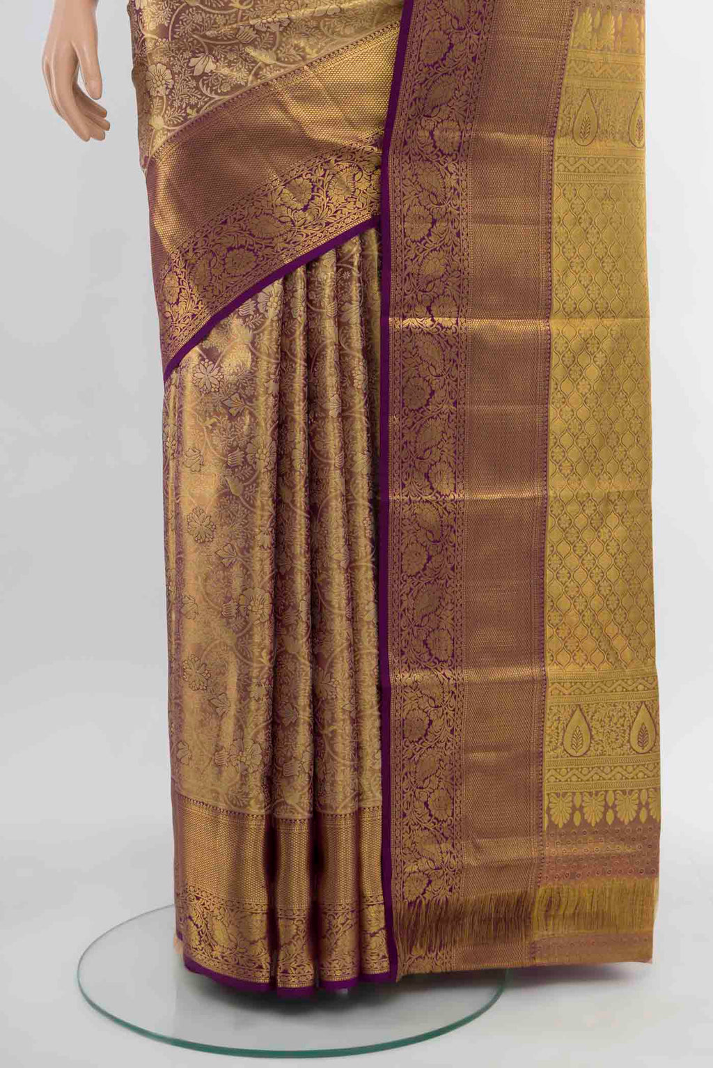 Pleats and pallu of Golden Kanchipuram Silk Saree with Zari Butta on the body and Silk Border. 