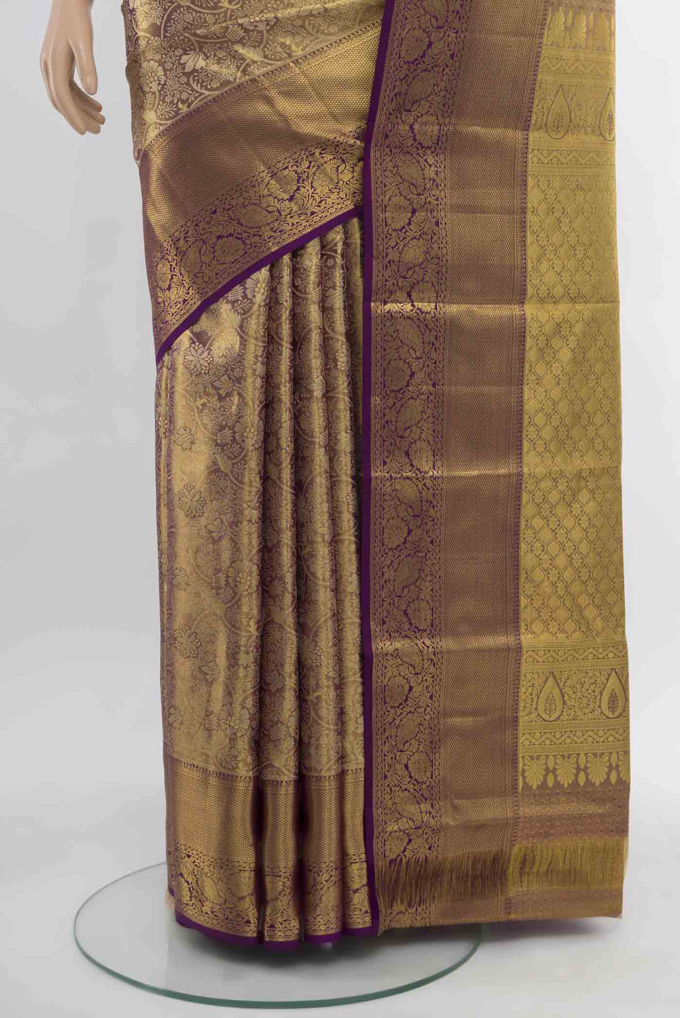 Pleats and pallu of Golden Kanchipuram Silk Saree with Zari Butta on the body and Silk Border. 