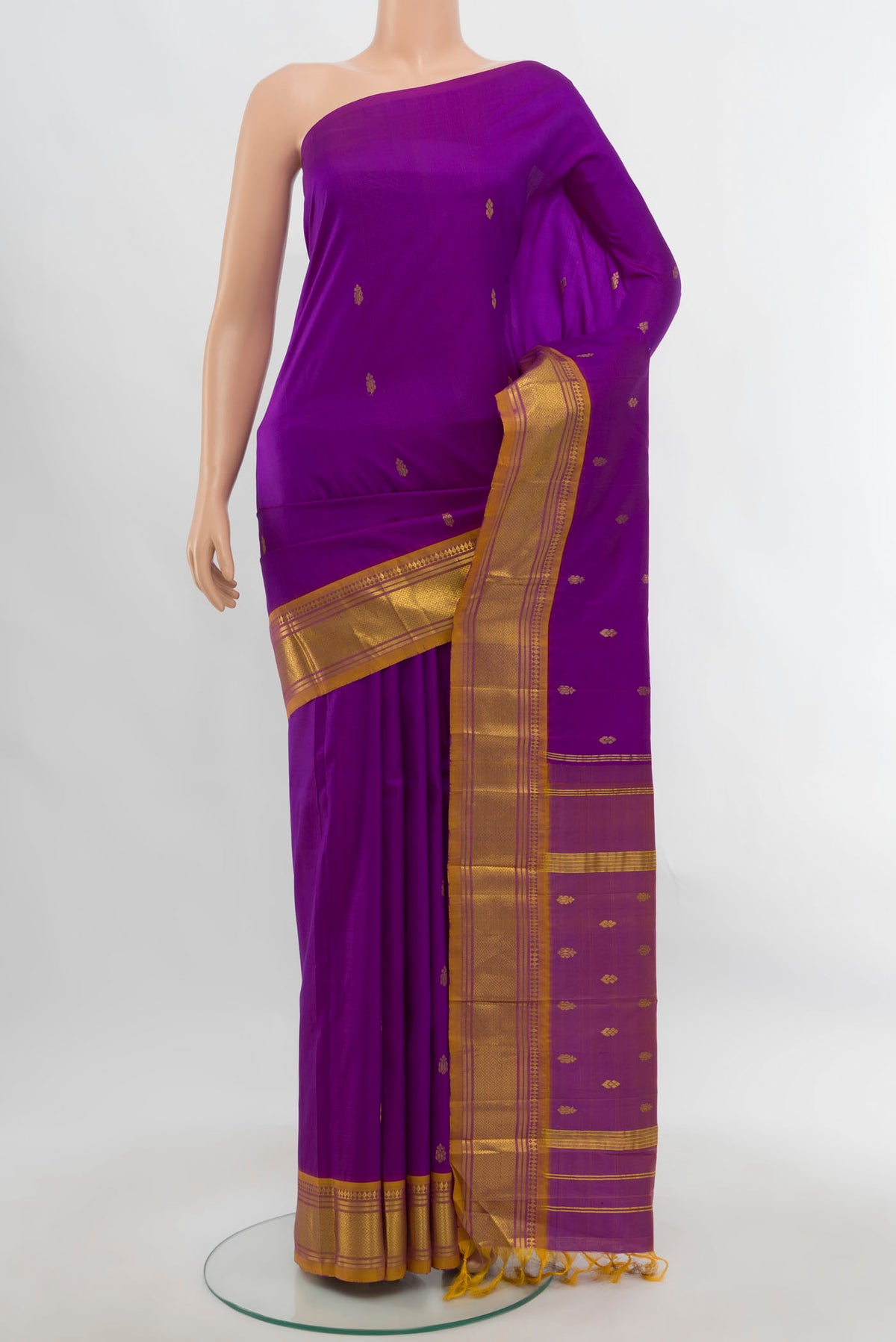 Purple Kanjivaram Silk Saree with Zari Butta on the body and Silk Border.  displayed on a mannequin