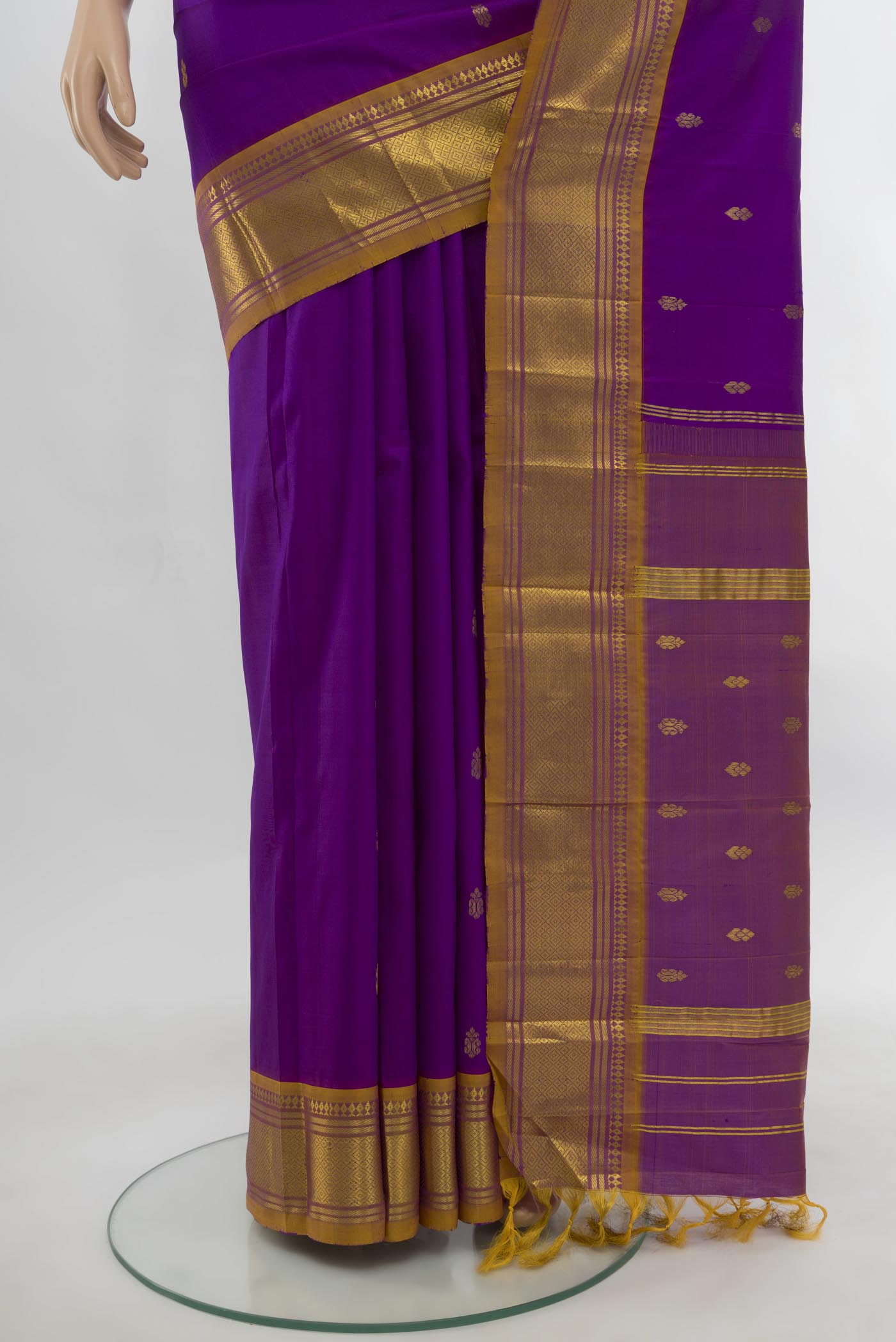 Pleats and pallu of Purple Kanjivaram Silk Saree with Zari Butta on the body and Silk Border. 