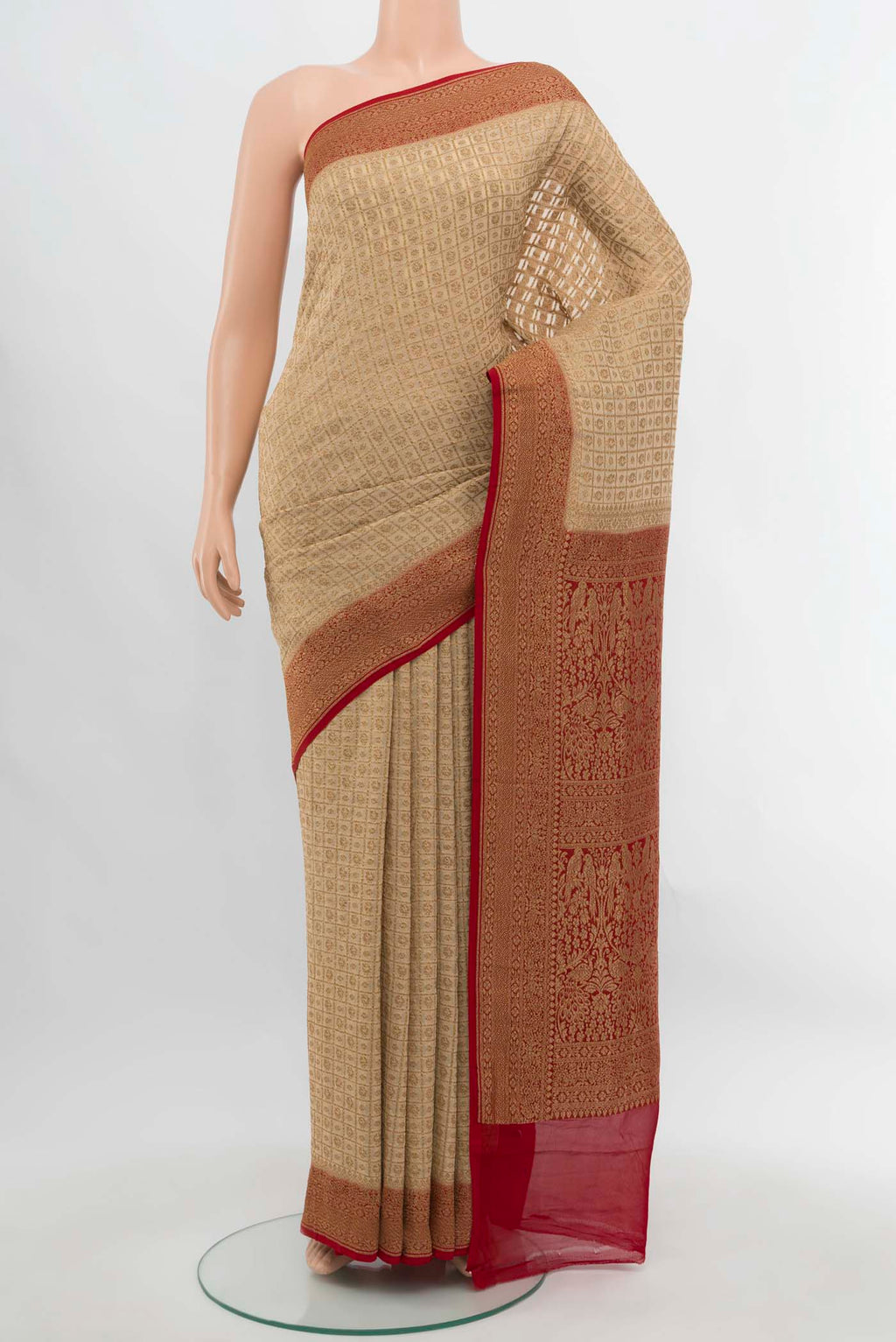 Cream Banarasi Georgette Saree with Zari Butta on the body and Silk Border.  displayed on a mannequin
