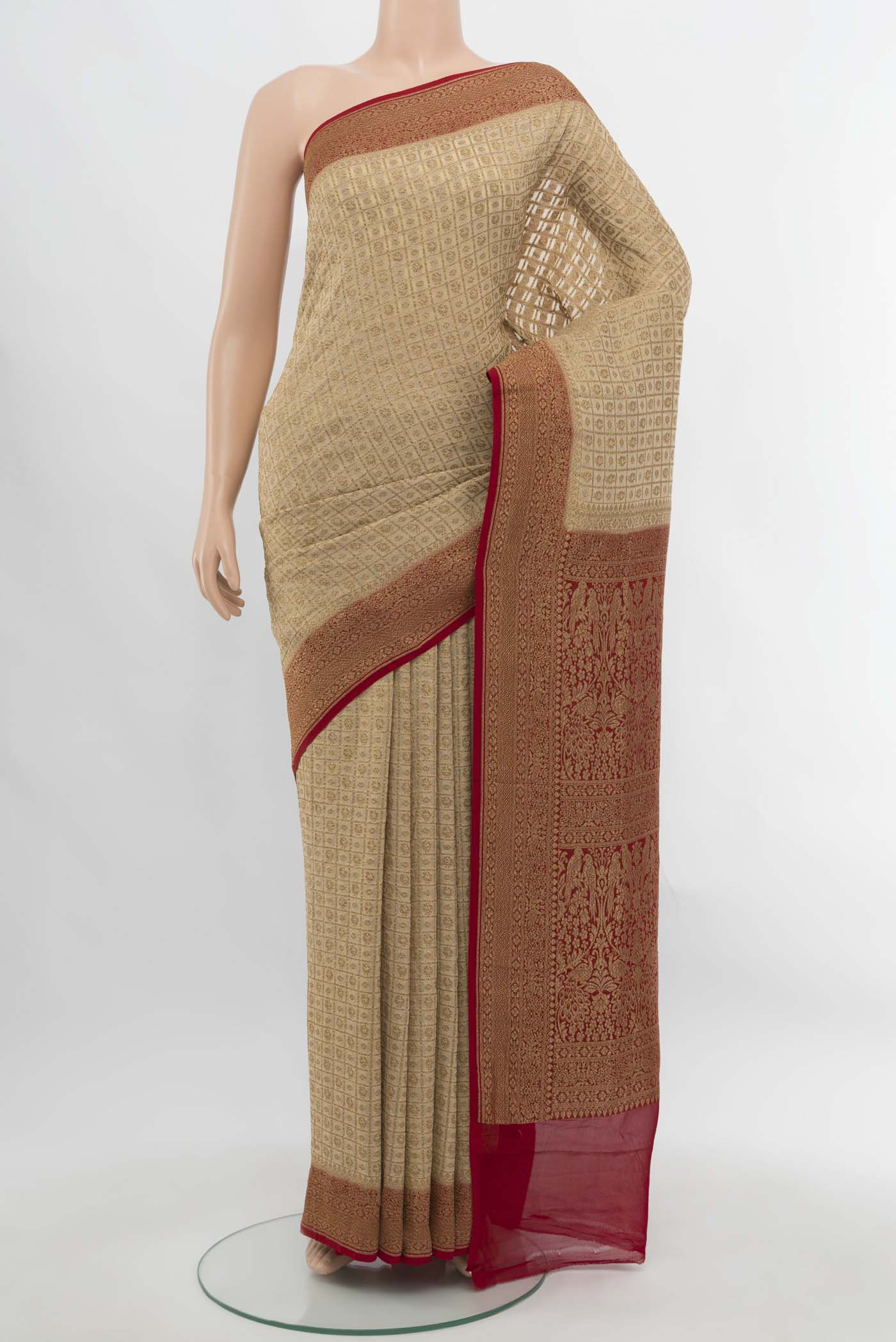 Cream Banarasi Georgette Saree with Zari Butta on the body and Silk Border.  displayed on a mannequin