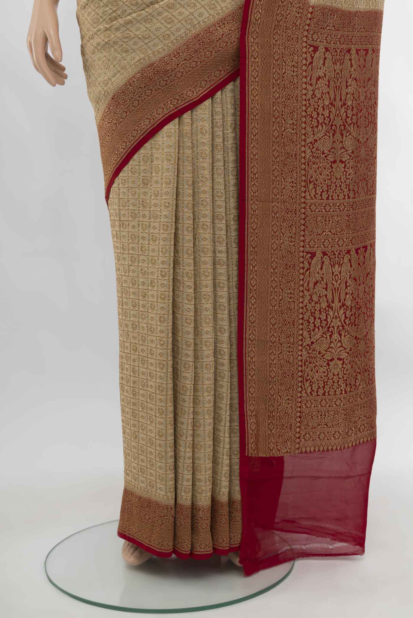 Pleats and pallu of Cream Banarasi Georgette Saree with Zari Butta on the body and Silk Border. 
