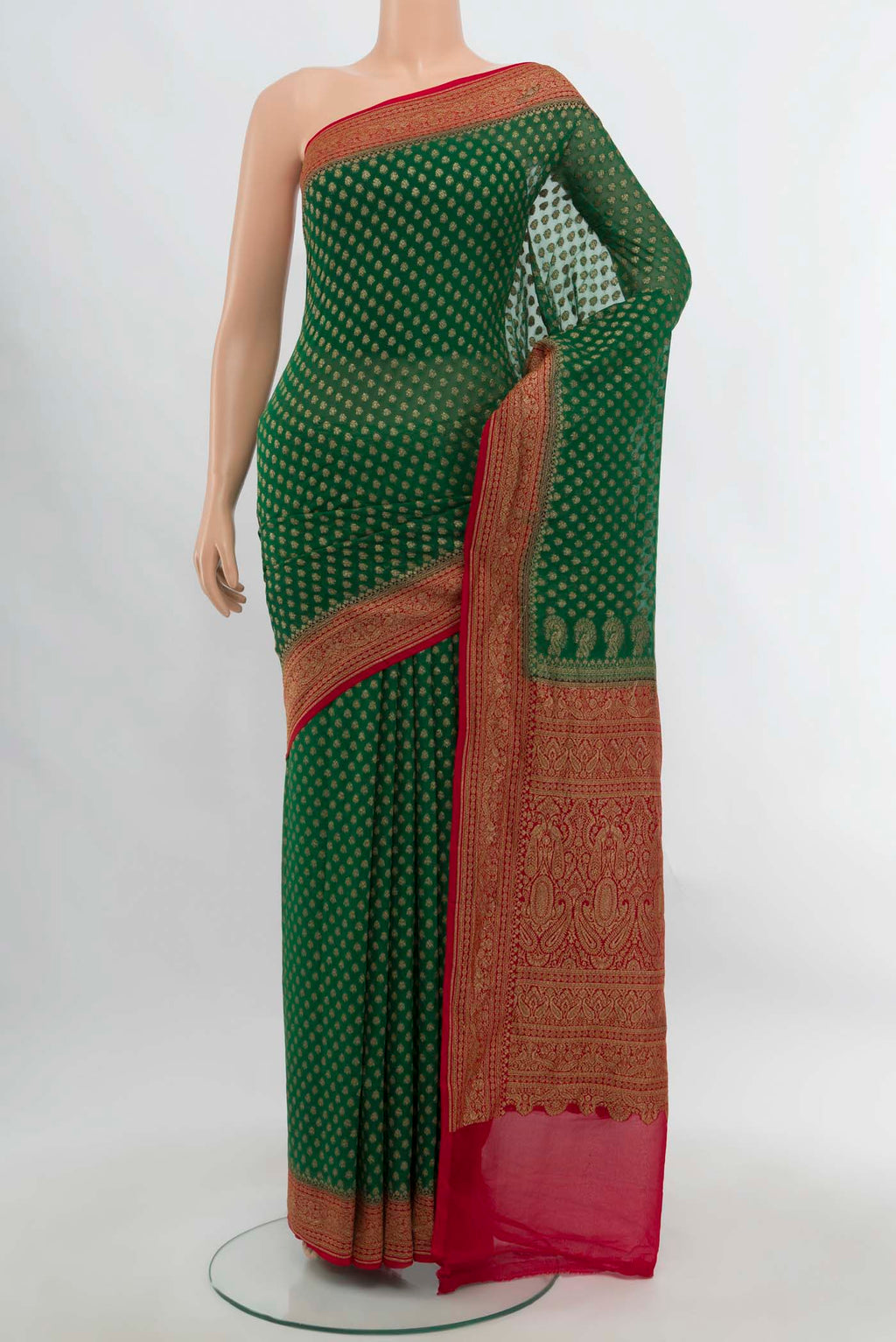 Bottle Green Banarasi Georgette Saree with Zari Butta on the body and Silk Border.  displayed on a mannequin