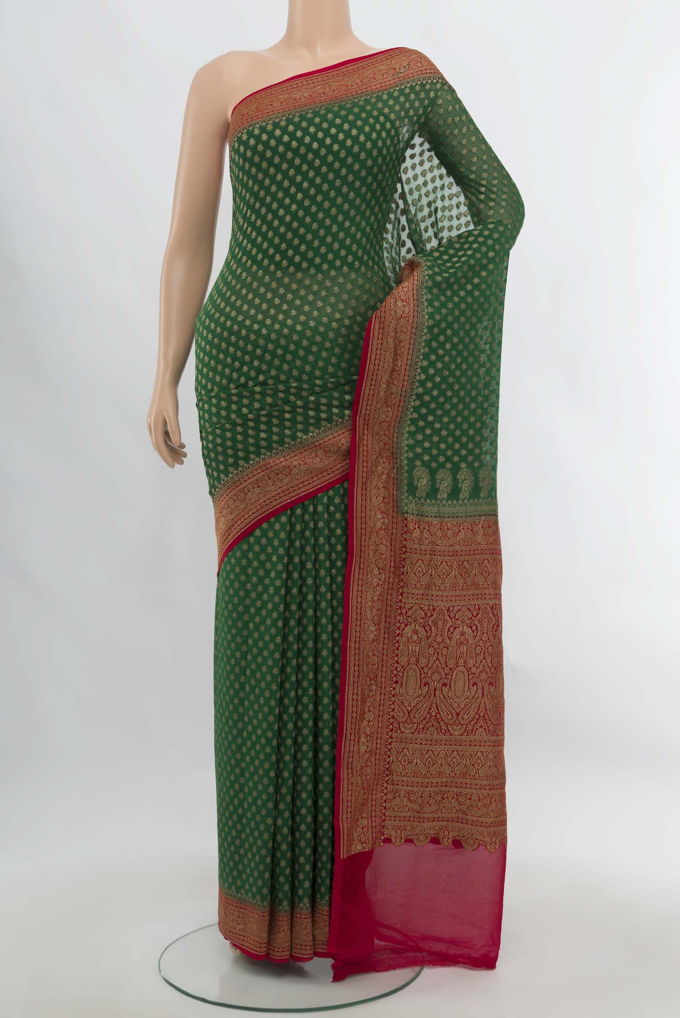 Bottle Green Banarasi Georgette Saree with Zari Butta on the body and Silk Border.  displayed on a mannequin