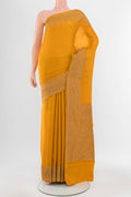 Mustard Mysore Crepe Saree with Zari Butta on the body and Silk Border.  displayed on a mannequin