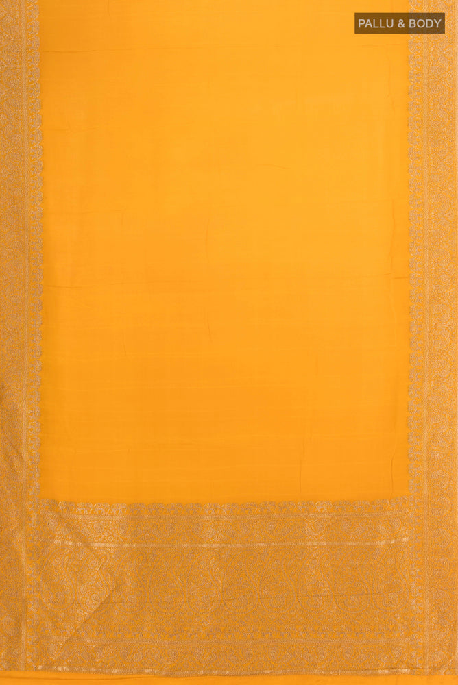 Flat view of Mustard Mysore Crepe Saree with Zari Butta on the body and Silk Border. 