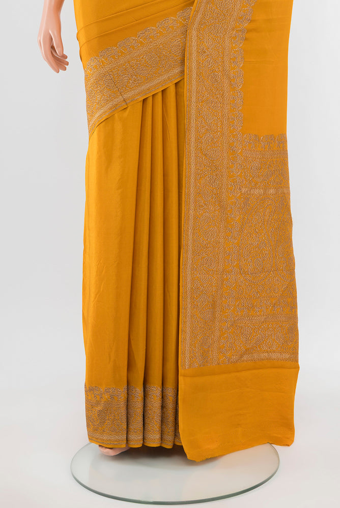 Pleats and pallu of Mustard Mysore Crepe Saree with Zari Butta on the body and Silk Border. 