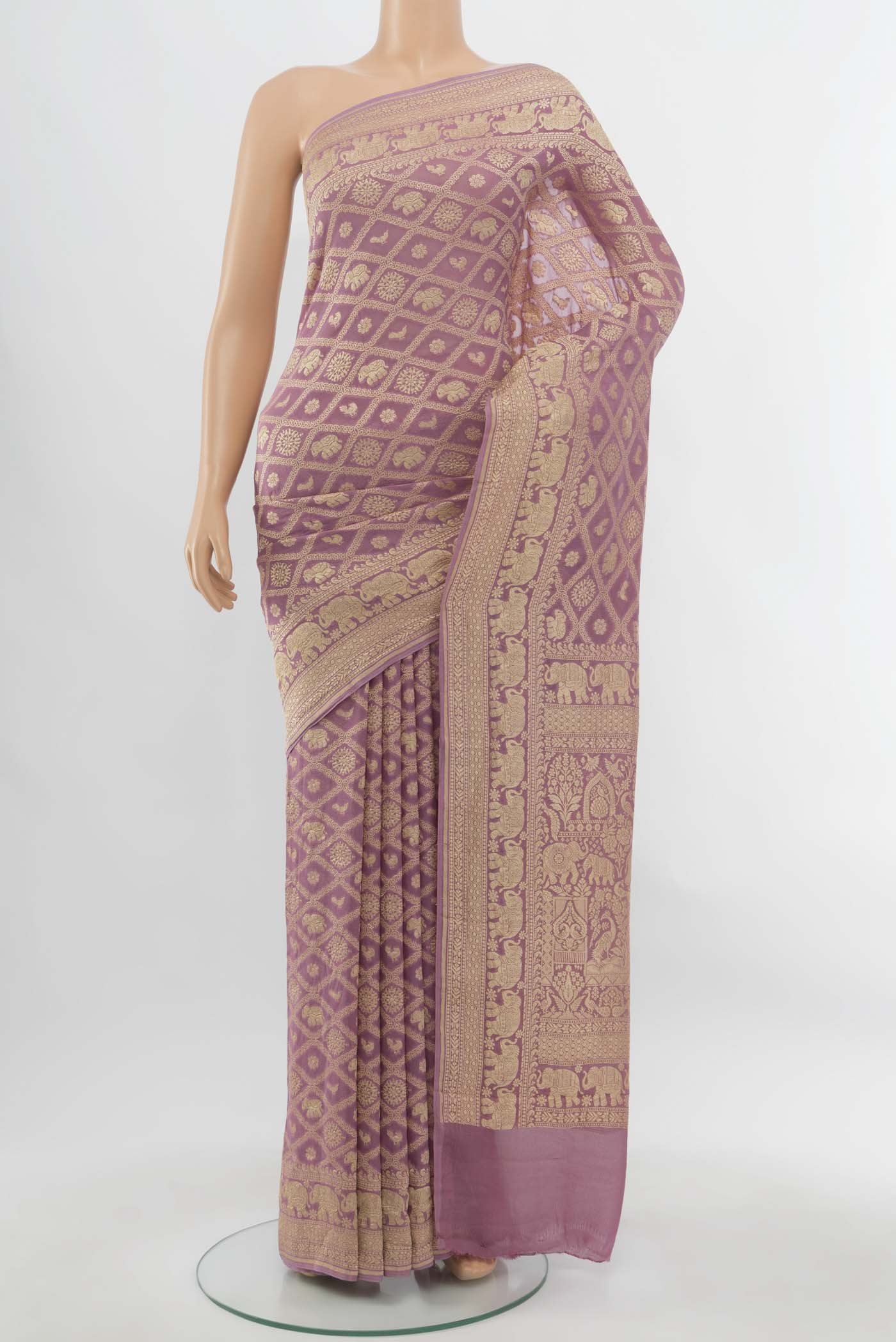 Golden Banarasi Georgette Saree with Zari Butta on the body and Silk Border.  displayed on a mannequin