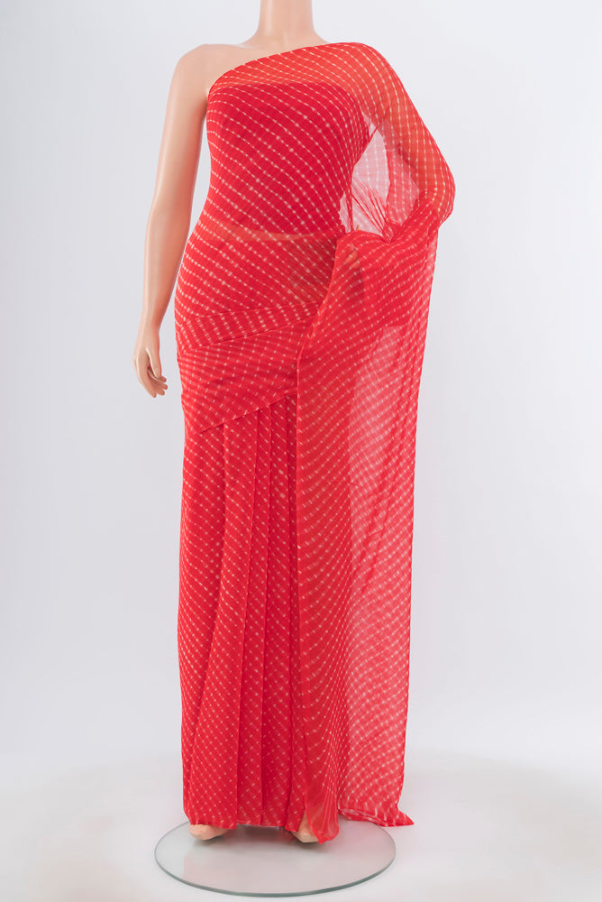Pure Silk Pure Zari Peach Bandhani Georgette Saree with Bandhani on the body and Checks Border.  displayed on a mannequin