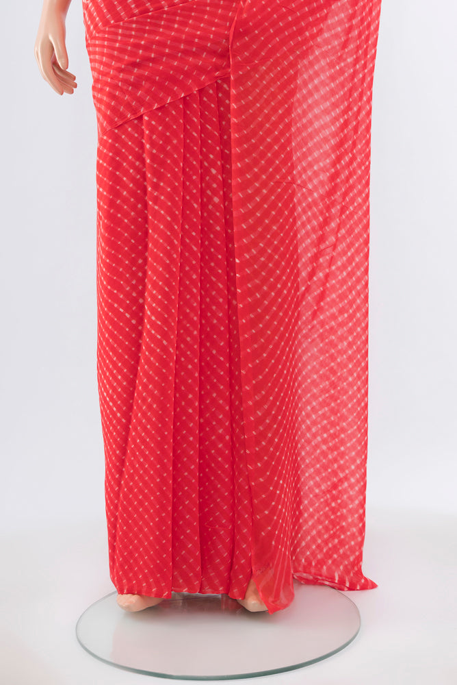 Pleats and pallu of Pure Silk Pure Zari Peach Bandhani Georgette Saree with Bandhani on the body and Checks Border. 