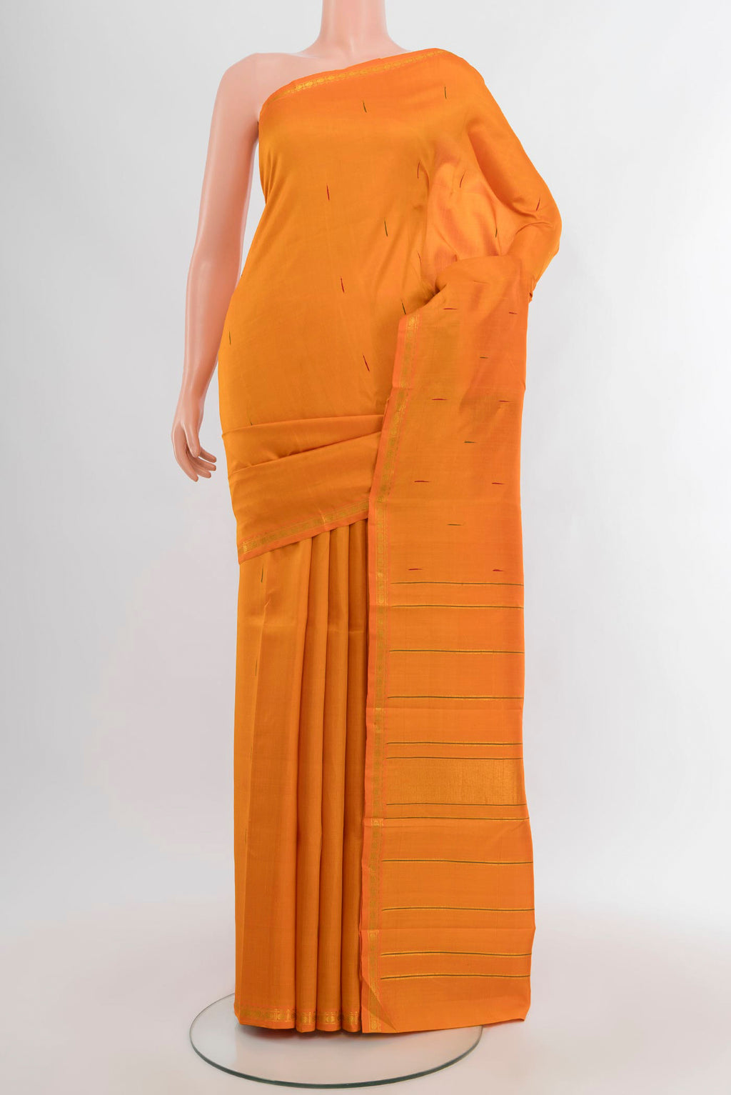 Brick Orange Kanchipuram Silk Saree with Zari Butta on the body and Zari Border.  displayed on a mannequin