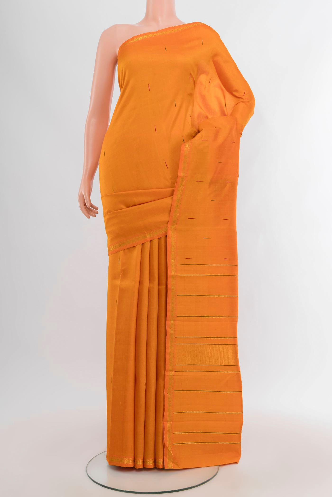 Brick Orange Kanchipuram Silk Saree with Zari Butta on the body and Zari Border.  displayed on a mannequin