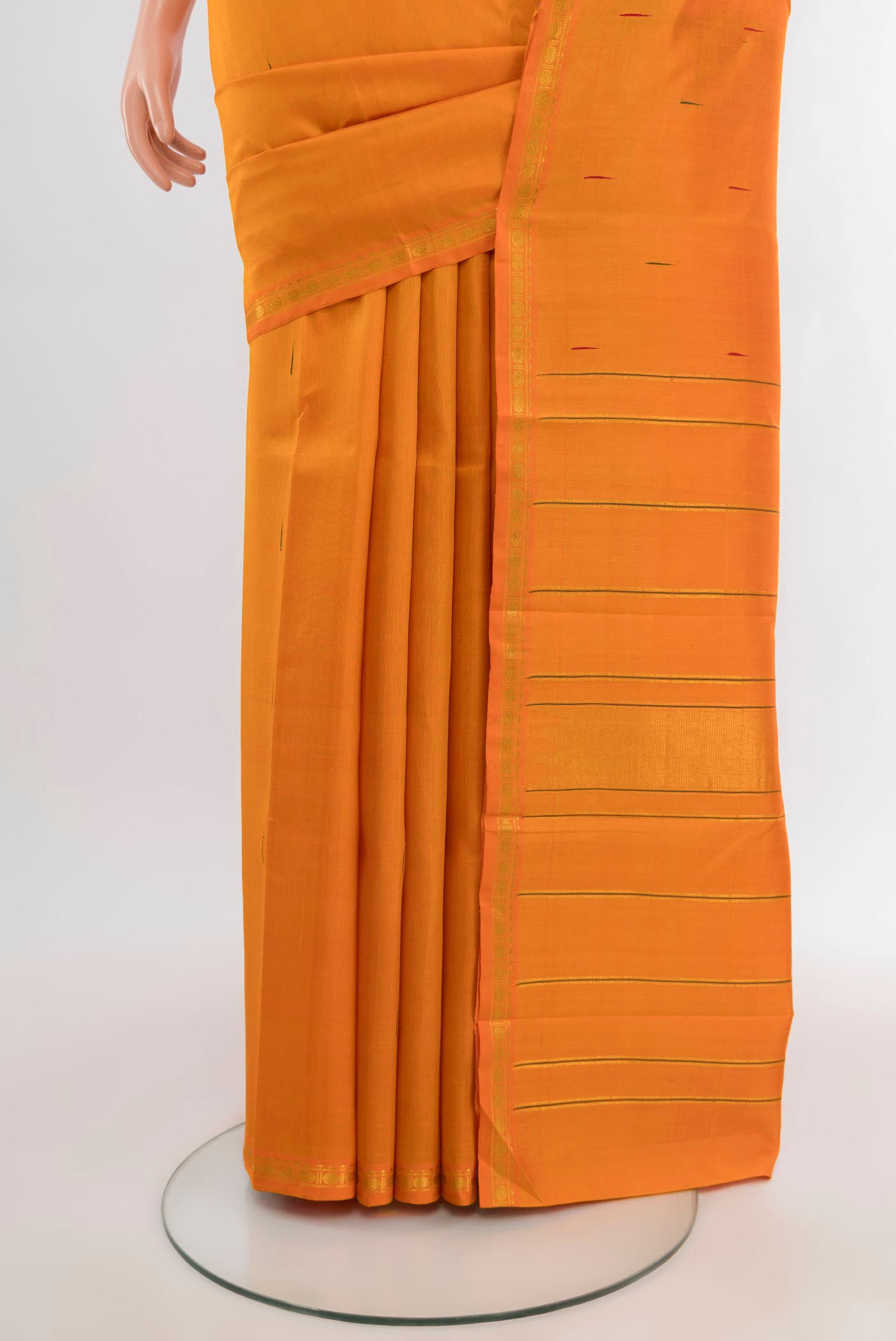 Pleats and pallu of Brick Orange Kanchipuram Silk Saree with Zari Butta on the body and Zari Border. 